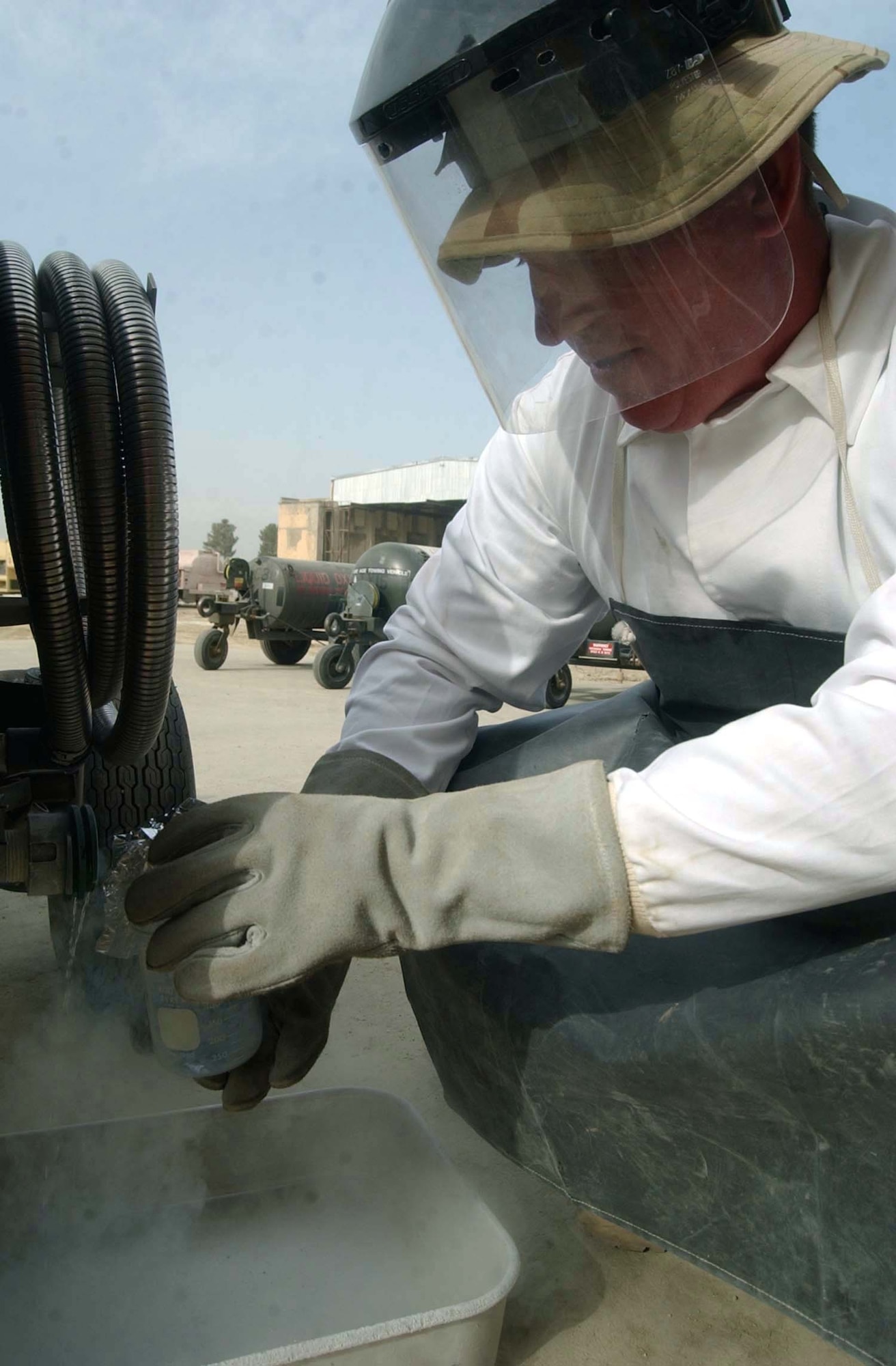 BAGRAM AIR BASE, Afghanistan -- Tech. Sgt. Robbie Bebee draws a liquid-oxygen sample from a cart that he just filled.  The liquid in the beaker is minus-297 degrees.  Sergeant Bebee is assigned to the 455th Expeditionary Operations Group fuels flight, and he is deployed from Davis-Monthan Air Force Base, Ariz.  (Air Force Photo by Maser Sgt. Jeff Szczechowski)