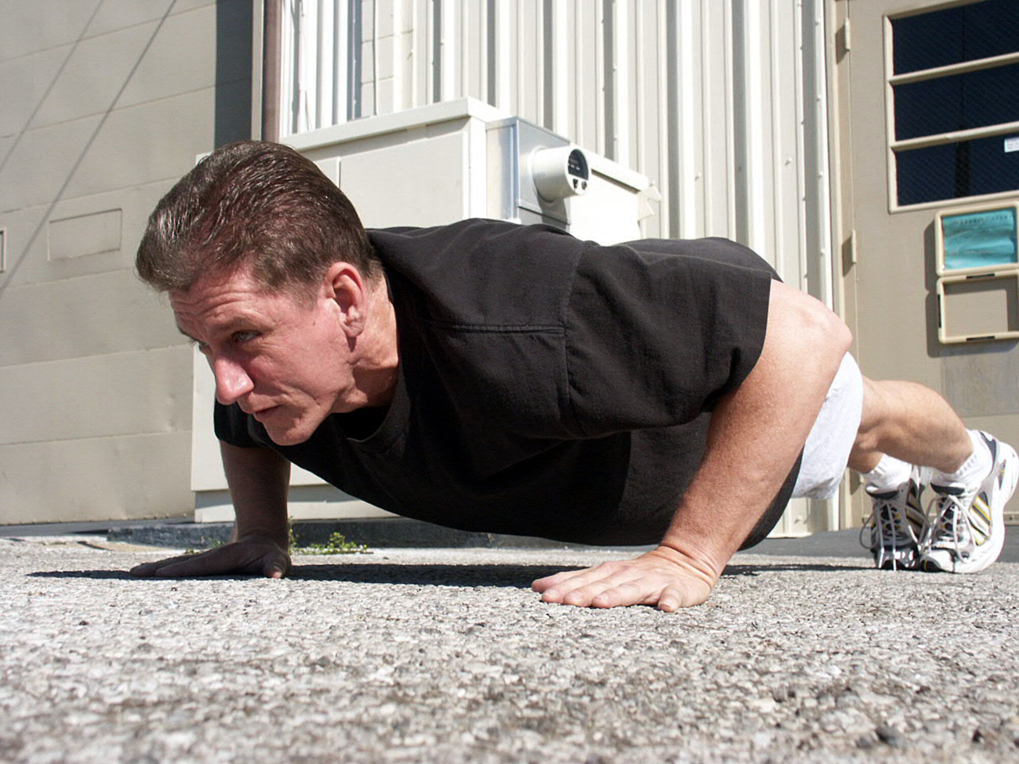 EGLIN AIR FORCE BASE, Fla. -- Master Sgt. Michael Moss pushes himself through some pushups.  Six months ago, Sergeant Moss was overweight and could not run half of the required distance to pass the new fitness test.  Now he is setting the example for his flight and said he is feeling better than he ever has. Sergeant Moss is assigned to the 33rd Maintenance Squadron's aerospace ground equipment flight.  (U.S. Air Force photo by Staff Sgt. Robert Zoellner)