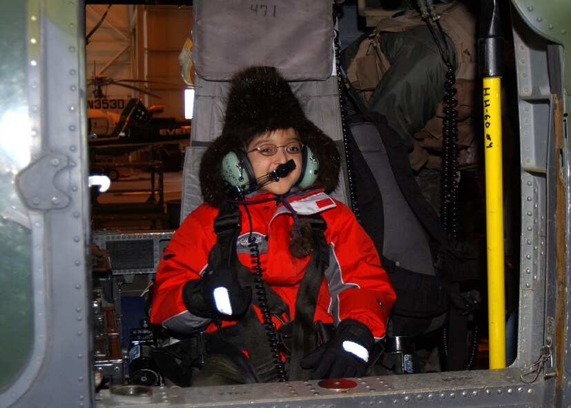 EIELSON AIR FORCE BASE, Alaska -- Kameron Ballard-Huffman gives a "thumbs-up" while sitting in a HH-60 Pave Hawk helicopter assigned to the Alaska Air National Guard's 210th Rescue Squadron.  He was the Fighter Pilot for a Day here March 18.  The program lets terminally ill children see what it is like to be a fighter pilot.  Kameron is in the end stage of a rare liver disease.  He is from Husila, Alaska, a town about 250 miles northwest of Fairbanks.  (U.S. Air Force photo by Senior Airman Joshua Strang)