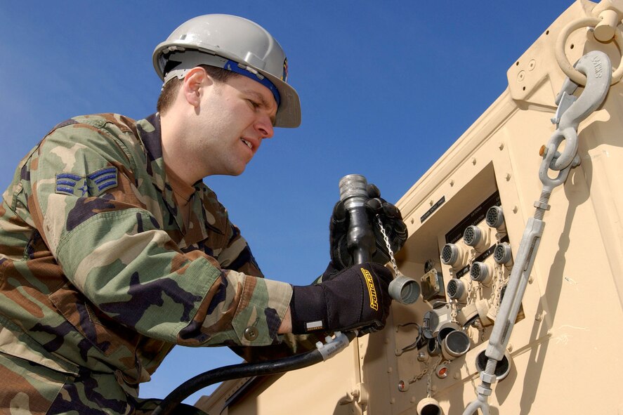 MCENTIRE AIR NATIONAL GUARD STATION, S.C. -- Senior Airman Stephen Aun helps set up a satellite antenna.  Airman Aun is assigned to the 240th Combat Communications Squadron here.  (U.S. Air Force photo by Tech. Sgt. Marvin R. Preston)
