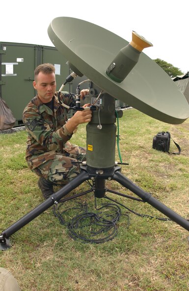HICKAM AIR FORCE BASE, Hawaii -- Staff Sgt. Christopher Kuhn double checks the connections of the lightweight multiband satellite terminal to maintain worldwide communications during the 56th ACOMS readiness training at Barbers Point Coast Guard Base on March 23. (U.S. Air Force photo by Michael Dey)