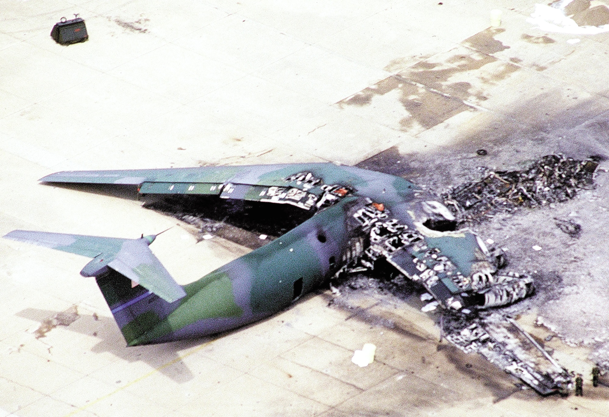 1990's -- POPE AIR FORCE BASE, N.C. -- An F-16 Fighting Falcon hit the tarmac in front of this C-141 Starlifter setting it on fire March 23, 1994.  The crash spread wreckage and burning fuel into an area where paratroopers waited to board the aircraft.  The accident killed 24 Soldiers and injured more than 100 others. (Courtesy photo)