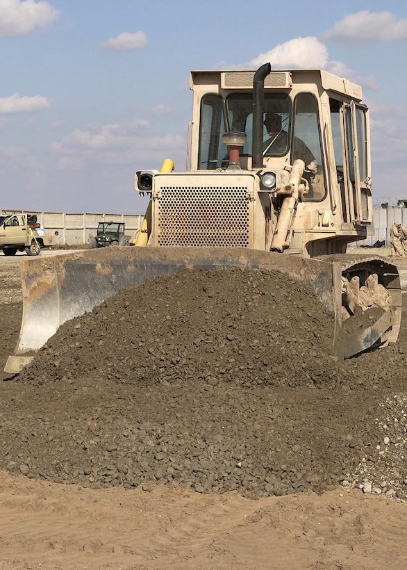 MANAS AIR BASE, Kyrgyzstan -- Staff Sgt. Todd Gauthier spreads construction grade materials at the fuels farm construction site here.  Sergeant Gathier and other Airmen of the 376th Expeditionary Civil Engineer Squadron will move more than 63 million pounds of dirt by the end of the project.  He is deployed from Ellsworth Air Force Base, S.D.  (U.S. Air Force photo by James Westfall)

                               