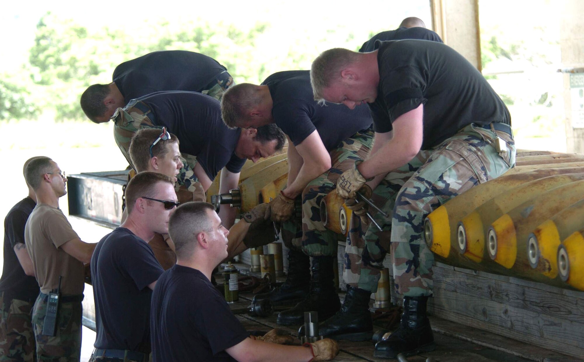 ANDERSEN AIR FORCE BASE, Guam -- Munitions workers assemble M-117 bombs here.  The Airmen are from the 5th Bomb Wing at Minot Air Force Base, N.D., and supporting B-52 Stratofortress training operations in the Pacific.  The wing is the first rotation to deploy to Guam following the decision to station a bomber force here.  (U.S. Air Force photo by Master Sgt. Val Gempis)