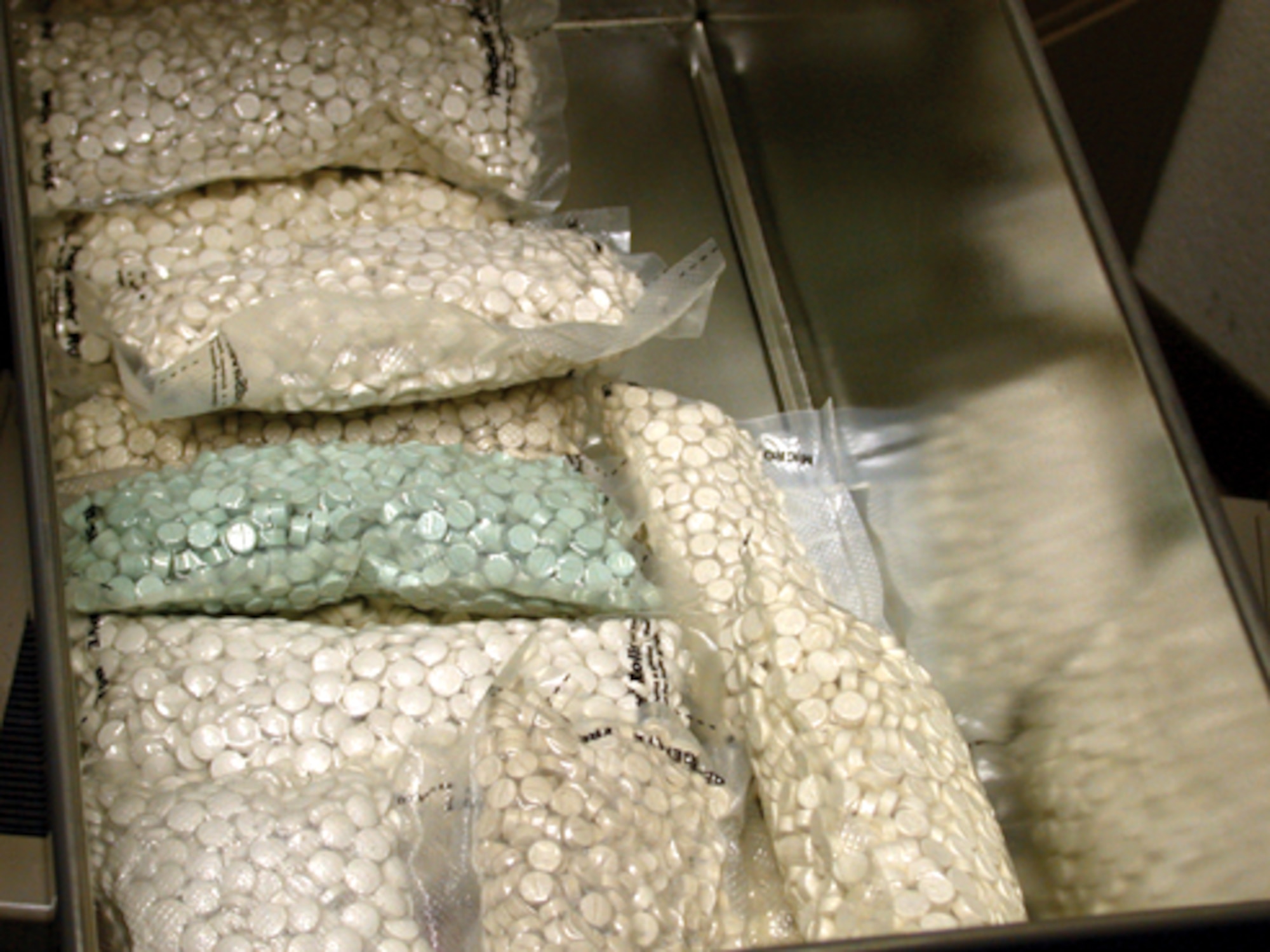 MOODY AIR FORCE BASE, Ga. -- Search teams uncovered more than 16,000 Ecstasy pills and $50,000 in cash belonging to Senior Airman Fredenburg stationed here.  Agents also seized three motor vehicles and a motorcycle, and they uncovered evidence that indicated he had tens of thousands of dollars in numerous investment accounts.  (Courtesy photo)