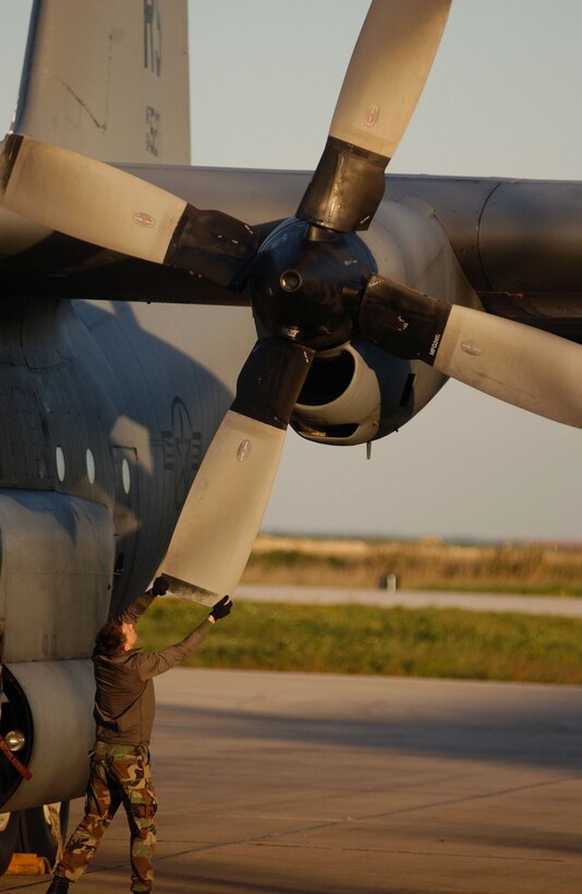 LISBON, Portugal -- Senior Airman Ryan Conti, a crew chief with the 37th Airlift Squadron, rotates the blades on a C-130 Hercules during post flight operations here. The aircraft will be the first to be refurbished by OGMA (Oficinas Gerais de Material Aeronáutico) Industries and returned to Ramstein Air Base, Germany. Seven more C-130s are scheduled for future refurbishments. (U.S. Air Force photo by Tech. Sgt. Justin D. Pyle)