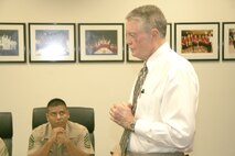 Gunnery Sgt. Andres Zayas gives Dr. Tom Osborne his undivided attention at the University of Nebraska athletics department conference room Sept. 23. Osborne took time out of his busy schedule to speak to the Marines of Recruiting Station Des Moines about leadership. Osborne is fifth on the all-time college coaches list for wins.