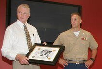 Dr. Tom Osborne talks about his father's service in World War II after receiving a heart-felt gift about his father from the Recruiting Station Des Moines Marines Sept. 23 at the University of Nebraska athletics department. Osborne spoke to the Marines about leadership and what it takes to obtain it. Osborne, the long-time coach for the university's historical football program now serves as the university's athletics director.