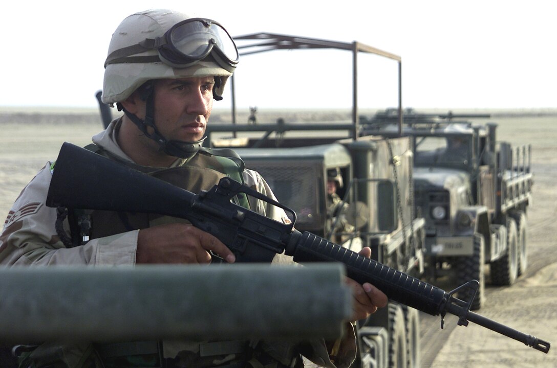 SOUTHWEST ASIA -- Senior Airman James McGregor scans the horizon for potential threats, preparing for a convoy operation.  Airman McGregor recently graduated from a training course designed to teach transportation Airmen how to survive during convoy operations in potentially hostile locations.  He is a vehicle operator deployed from the Air Force Reserve's 939th Air Refueling Wing at Portland International Airport.  (U.S. Air Force photo by Capt. Tom Knowles)