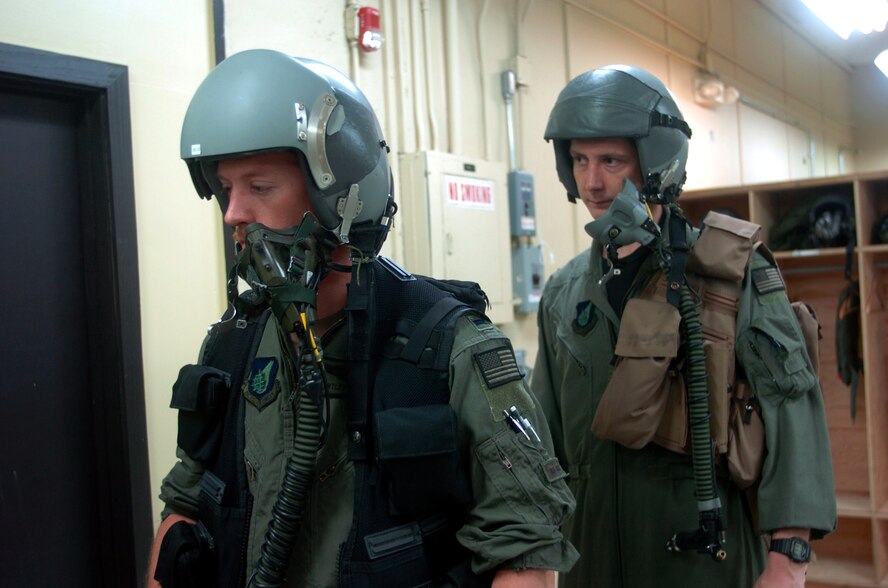 ANDERSEN AIR FORCE BASE, Guam -- Capt. Robby Castle (right), a radar navigator, and 1st Lt. Bentley Brooks, a pilot, wait to have their oxygen mask tested prior to a mission here.  Six B-52 Stratofortresses and about 300 support people from Minot Air Force Base, N.D., are the first to deploy here following the decision to station a rotating bomber force here.  Both Airmen are from the 23rd Bomb Squadron at Minot AFB.  (U.S. Air Force photo by Master Sgt. Val Gempis)