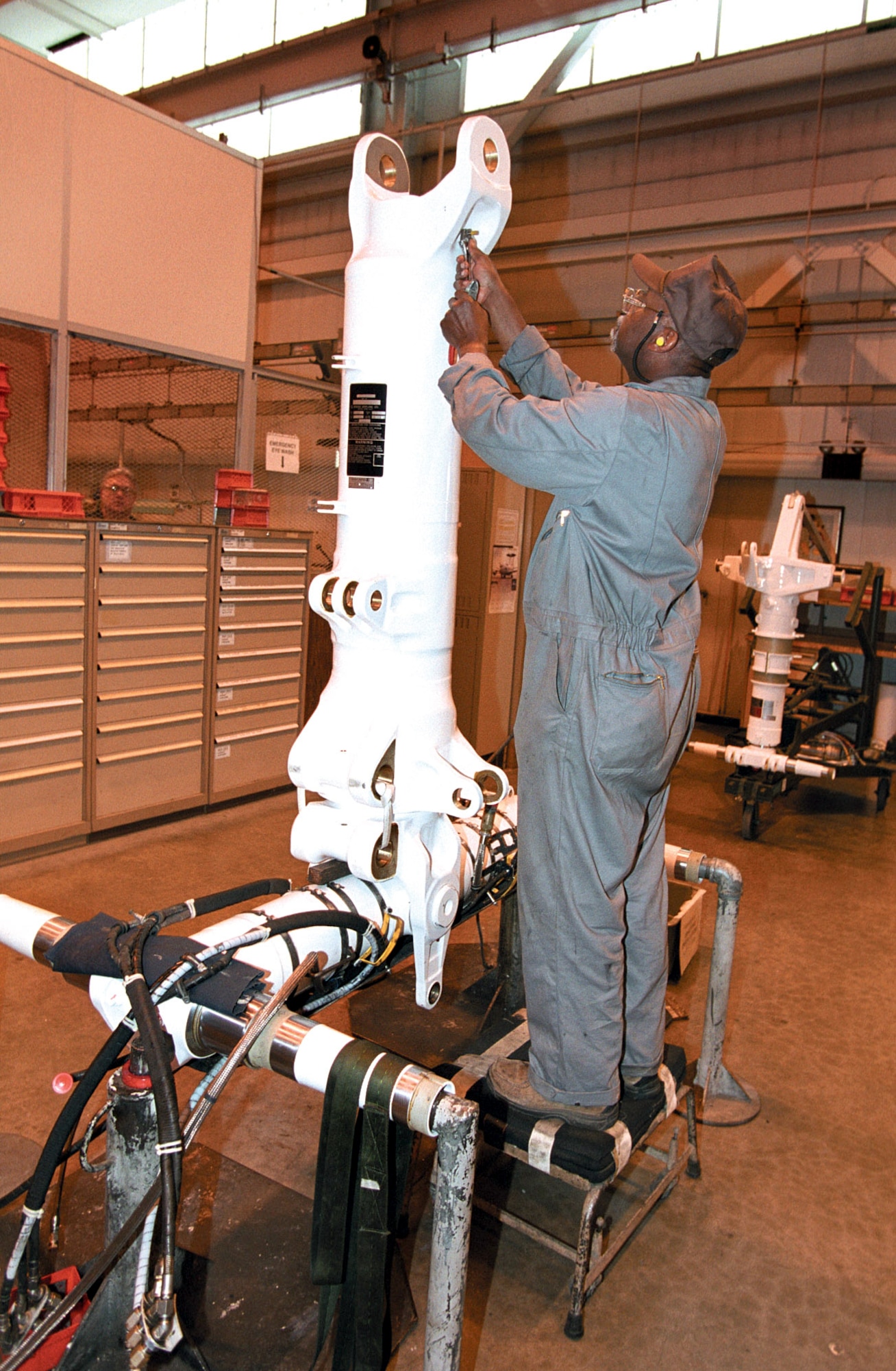 TINKER AIR FORCE BASE, Okla. -- Wallace Edwards, a work leader, loosens a valve so he can add hydraulic fluid to an E-3 Sentry's main landing gear before checking for leaks.  (U.S. Air Force photo by Margo Wright)