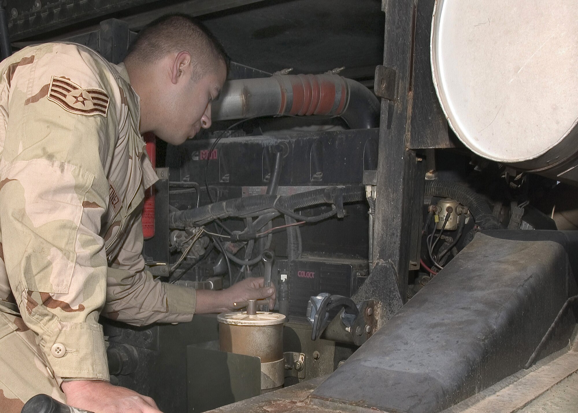 MANAS AIR BASE, Kyrgyzstan -- Staff Sgt. Rodrigo Martinez inspects the starter on the diesel motor of the Condor de-icing vehicle while performing repairs.  He is a vehicle maintainer with the 376th Expeditionary Logistics Readiness Squadron here and is deployed from Dyess Air Force Base, Texas.  (U.S. Air Force photo by James Westfall)


