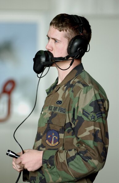 SPANGDAHLEM AIR BASE, Germany -- Airman First Class William Burrows communicates with a pilot to ensure that all checks of the outer and inner operational functions of the aircraft have been completed before taking off here April 26.  Airman Burrows is assigned to the 52nd Aircraft Maintenance Squadron.  (U.S. Air Force photo by Airman First Class Joshua E. Coleman)