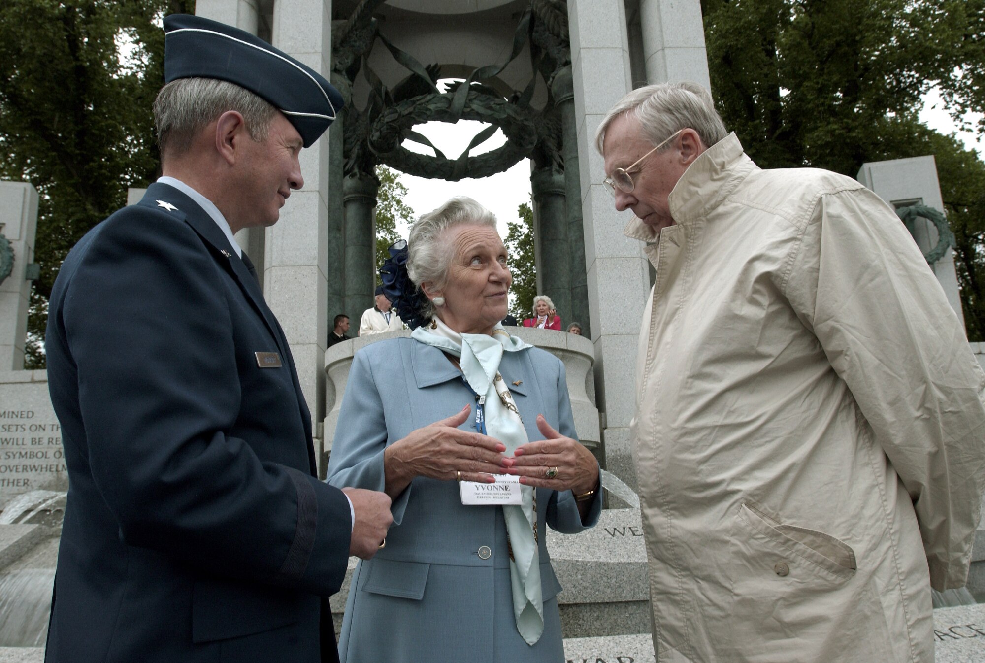 WASHINGTON -- Secretary of the Air Force Dr. James G. Roche (right) visits with Yonne Daley (center) and Lt. Gen. Duncan J. McNabb, deputy chief of staff for plans and programs, while at the newly opened World War II Memorial here May 3.  Ms. Daley who had organized the tour and General McNabb, who sponsored the group, were with members of the Air Forces Escape and Evasion Society.  The society comprises both U.S. Airmen who successfully evaded capture after bailing out of their aircraft over Europe in World War II and a number of the European civilians who helped them.  (U.S. Air Force by Master Sgt. Jim Varhegyi) 