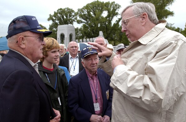WASHINGTON -- Secretary of the Air Force Dr. James G. Roche (right) visits with members of the Air Forces Escape and Evasion Society at the newly opened World War II Memorial here May 3.  The society, formed in 1964 by former B-17 pilot Ralph Patton (center in hat), comprises both U.S. Airmen who successfully evaded capture after bailing out of their aircraft over Europe in World War II and a number of the European civilians who helped them.  (U.S. Air Force by Master Sgt. Jim Varhegyi) 