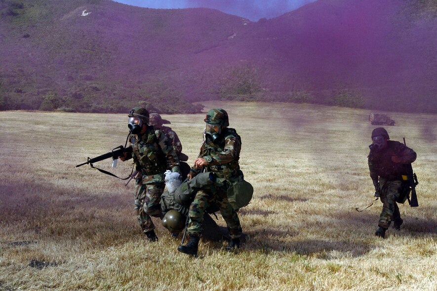 VANDENBERG AIR FORCE BASE, Calif. -- Members from the 90th Space Wing, F.E. Warren Air Force Base, Wyo. execute a rescue scenario during the marksmanship competition for Guardian Challenge here May 4.  Guardian Challenge, the world's premier space and missile competition, is a four-day event held annually.  It tests the wartime readiness of Air Force Space Command's Airmen in spacelift, ICBM operations, communications, maintenance, helicopter operations, security forces and chef food preparation.  (U.S. Air Force photo by Staff Sgt. James A. Williams) 
