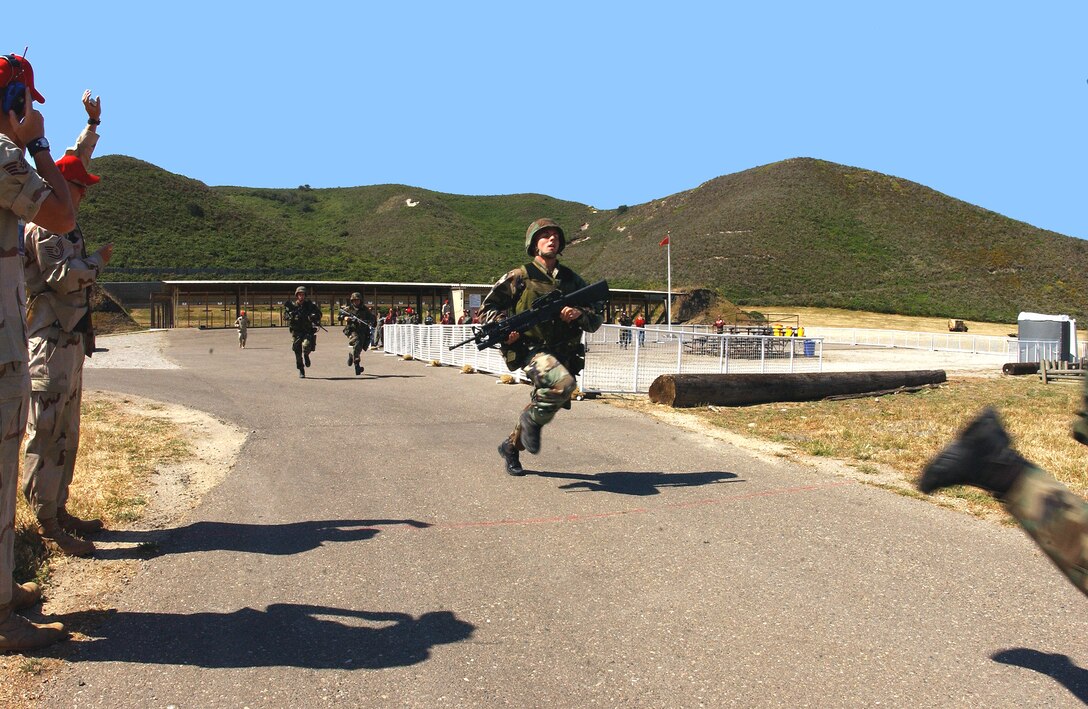 VANDENBERG AIR FORCE BASE, Calif. -- Security forces personnel from the 91st Space Wing, aka "The Roughriders," Minot Air Force Base, N.D.  sprint across the line completing the first half of the marksmanship competition for Guardian Challenge here May 4.  Guardian Challenge, the world's premier space and missile competition, is a four-day event held annually.  It tests the wartime readiness of Air Force Space Command's Airmen in spacelift, ICBM operations, communications, maintenance, helicopter operations, security forces and chef food preparation.  (U.S. Air Force photo by Staff Sgt. Jennifer C. Wallis) 
