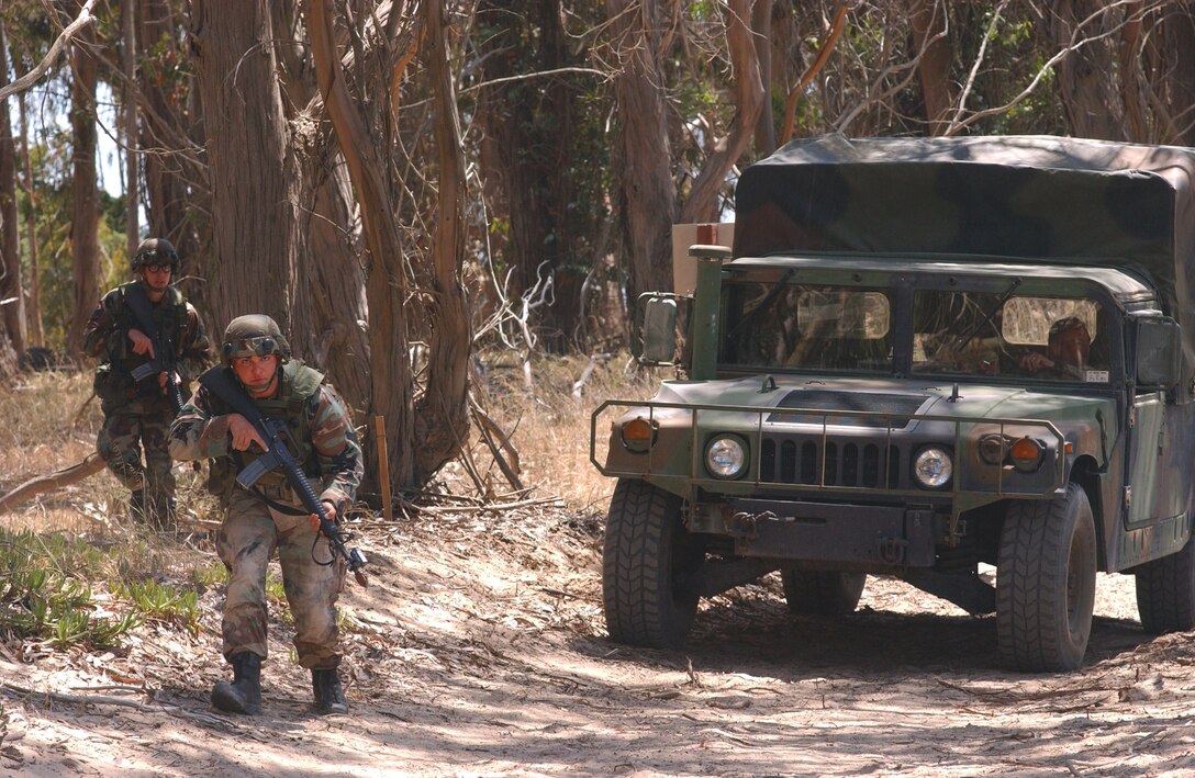 VANDENBERG AIR FORCE BASE, Calif. -- Airman 1st Class Christopher Dickerson searches the area for aggressors during the security forces tactics competition for Guardian Challenge here May 4.  Guardian Challenge, the world's premier space and missile competition, is a four-day event held annually.  It tests the wartime readiness of Air Force Space Command's Airmen in spacelift, ICBM operations, communications, maintenance, helicopter operations, security forces and chef food preparation.  Airman Dickerson is assigned to the 460th Air Base Wing, Buckley Air Force Base, Colo.  (U.S. Air Force photo by Airman Kyle R. Fidel)
