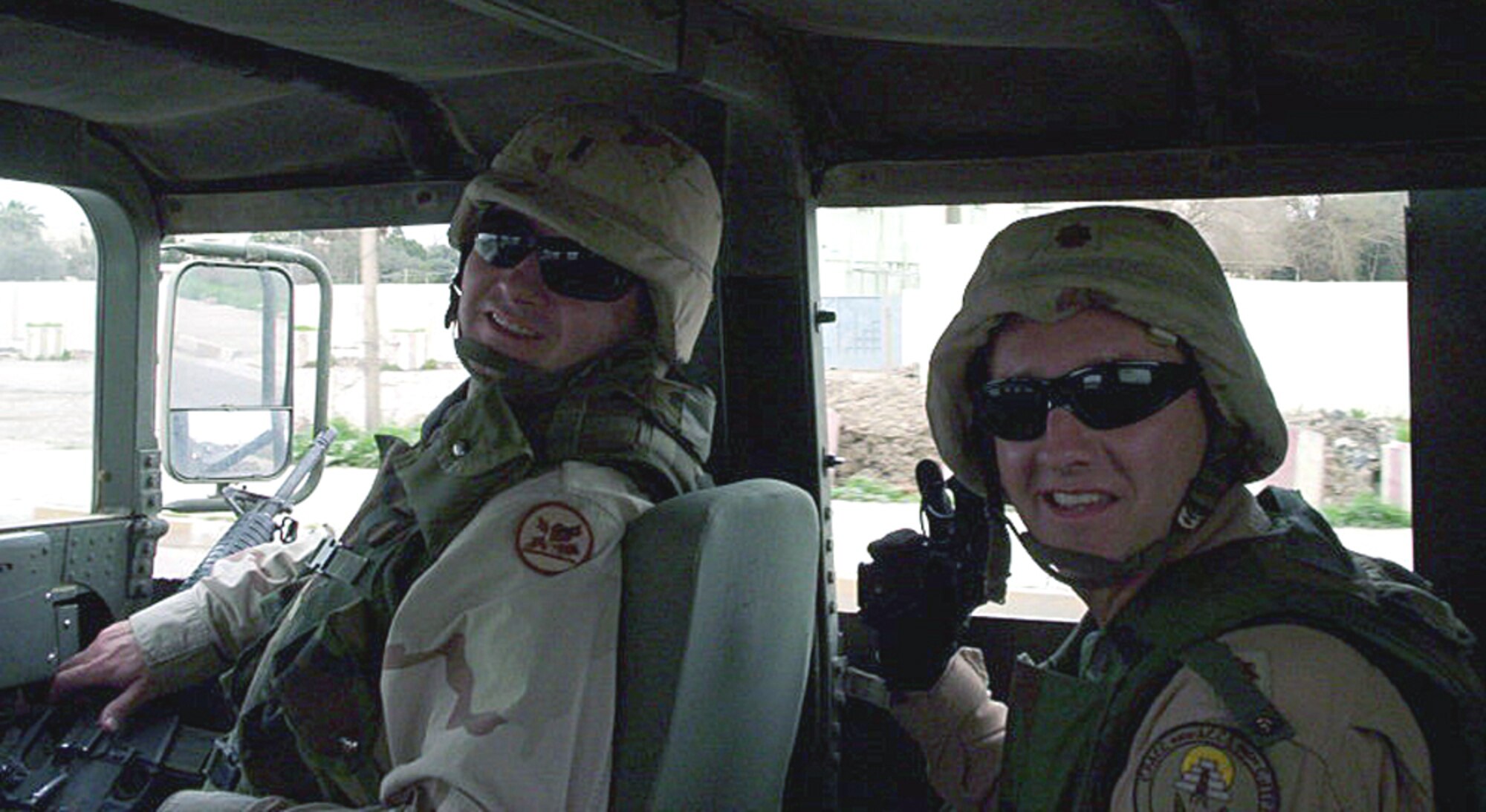 MOSUL, Iraq -- Then-Maj. Greg Harbin (right) and his younger brother, Army 1st Lt. Eric Harbin, share a smile here before setting off.  Lieutenant Harbin escorted his visiting brother through the combat zone to the headquarters here recently.  Lt. Col. Greg Harbin, who was promoted May 1, is deployed from 9th Air Force headquarters at Shaw Air Force Base, S.C.  Lieutenant Harbin is a member of the Alabama National Guard.  (Courtesy photo)