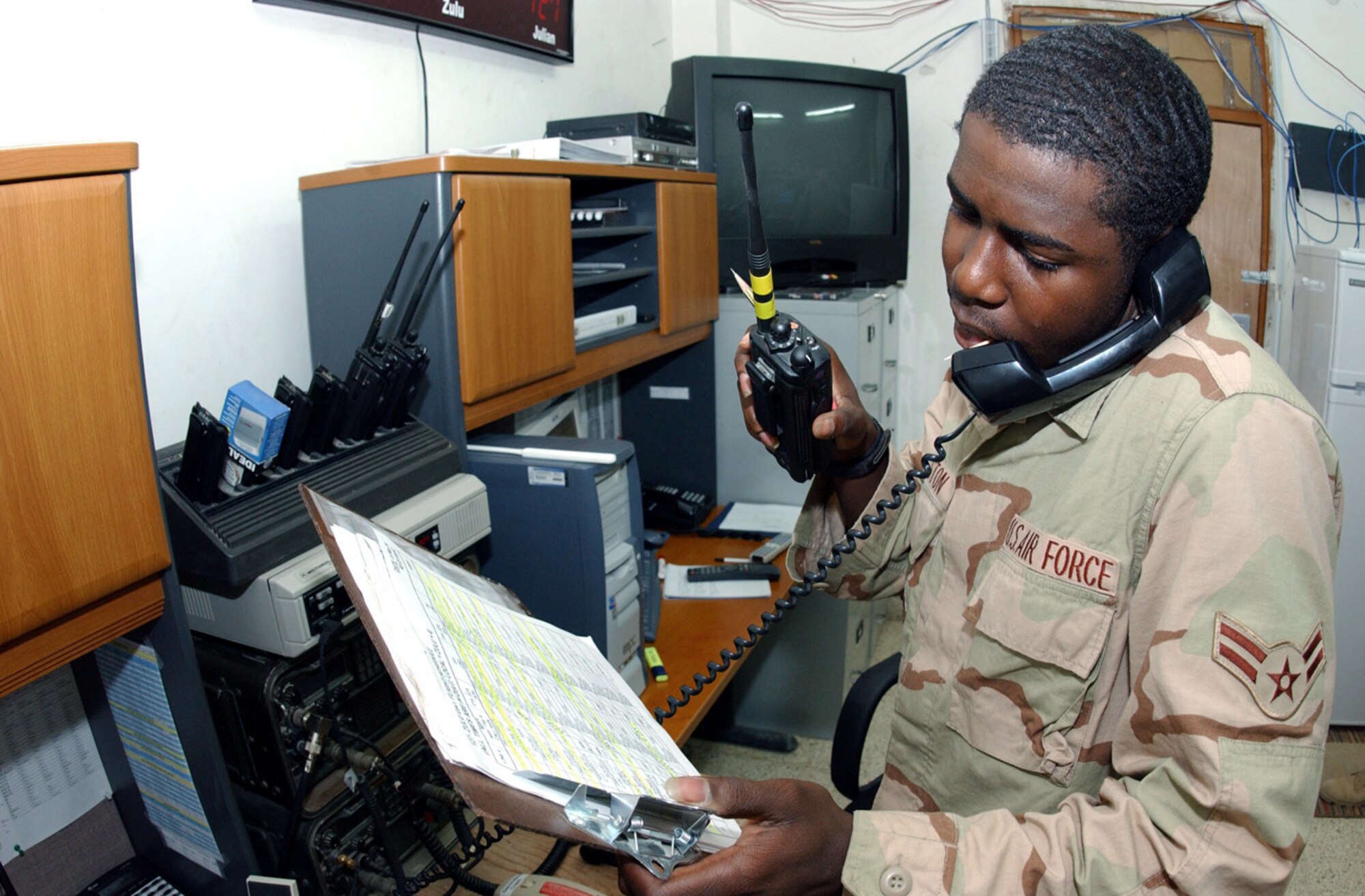 BALAD AIR BASE, Iraq -- Airman 1st Class Kevin Preston Jr. relays information from an aircrew to maintainers.  He is an emergency action controller with the 322nd Air Expeditionary Wing's command post here and is deployed from Cannon Air Force Base, N.M.  (U.S. Air Force photo by Master Sgt. Jon Hanson)
