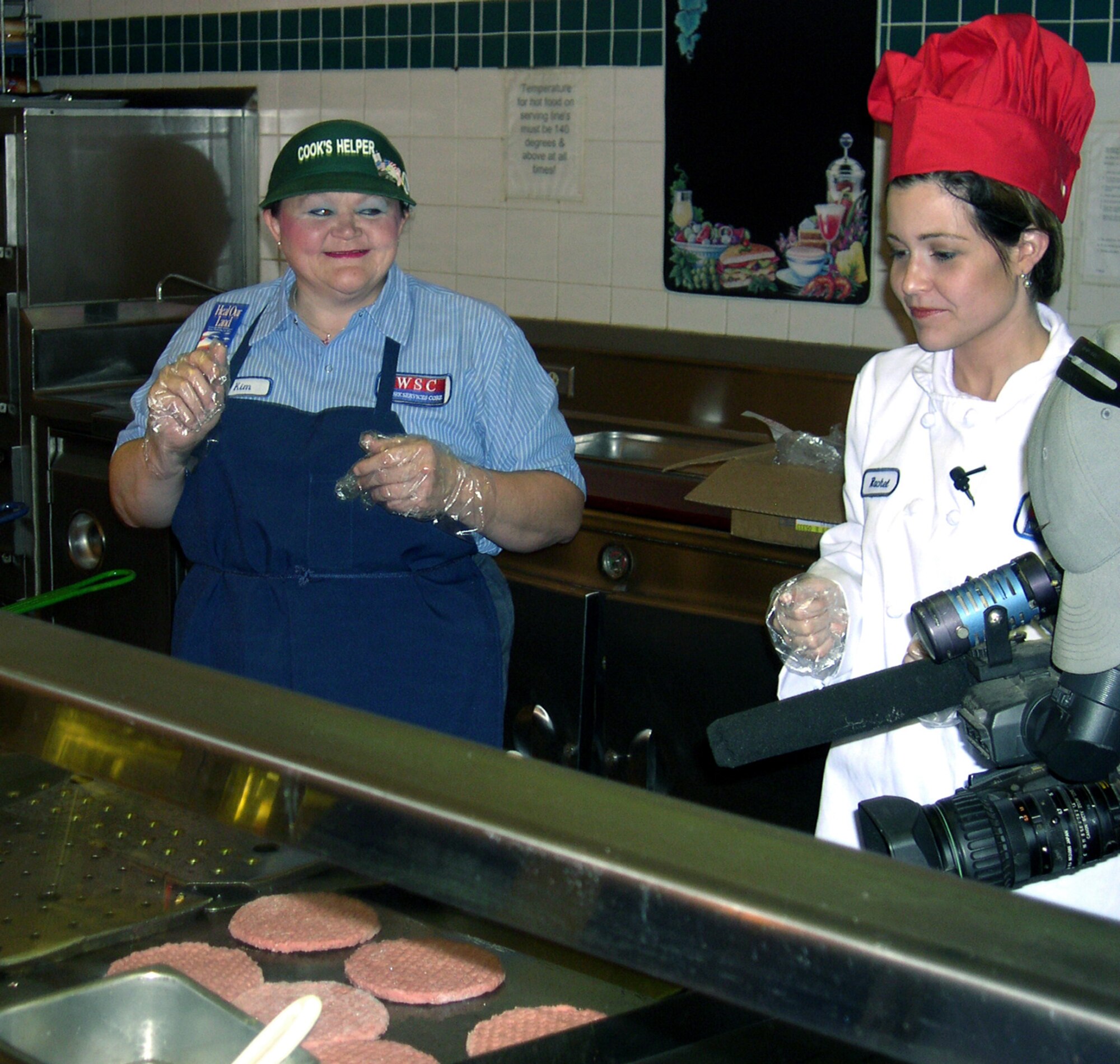 SHEPPARD AIR FORCE BASE, Texas -- Kimbra Lyons (left) works the grill at the 360th Training Squadron's dining facility with Rachel Wheat.  Ms. Wheat is a reporter and "Midday Edition" host for a local news station in Wichita Falls.  The two women swapped jobs after Ms. Lyons won a contest the news station was having.  (U.S. Air Force photo by Airman 1st Class Jacque Lickteig)