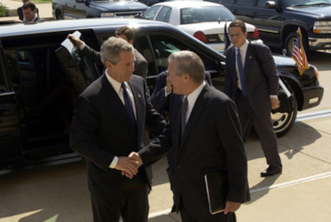 Secretary of Defense Donald H. Rumsfeld welcomes President George W. Bush to the Pentagon on May 10, 2004. Bush and his national security team will meet in the Pentagon for a briefing from senior DoD officials and military commanders in the field via video teleconferencing. 