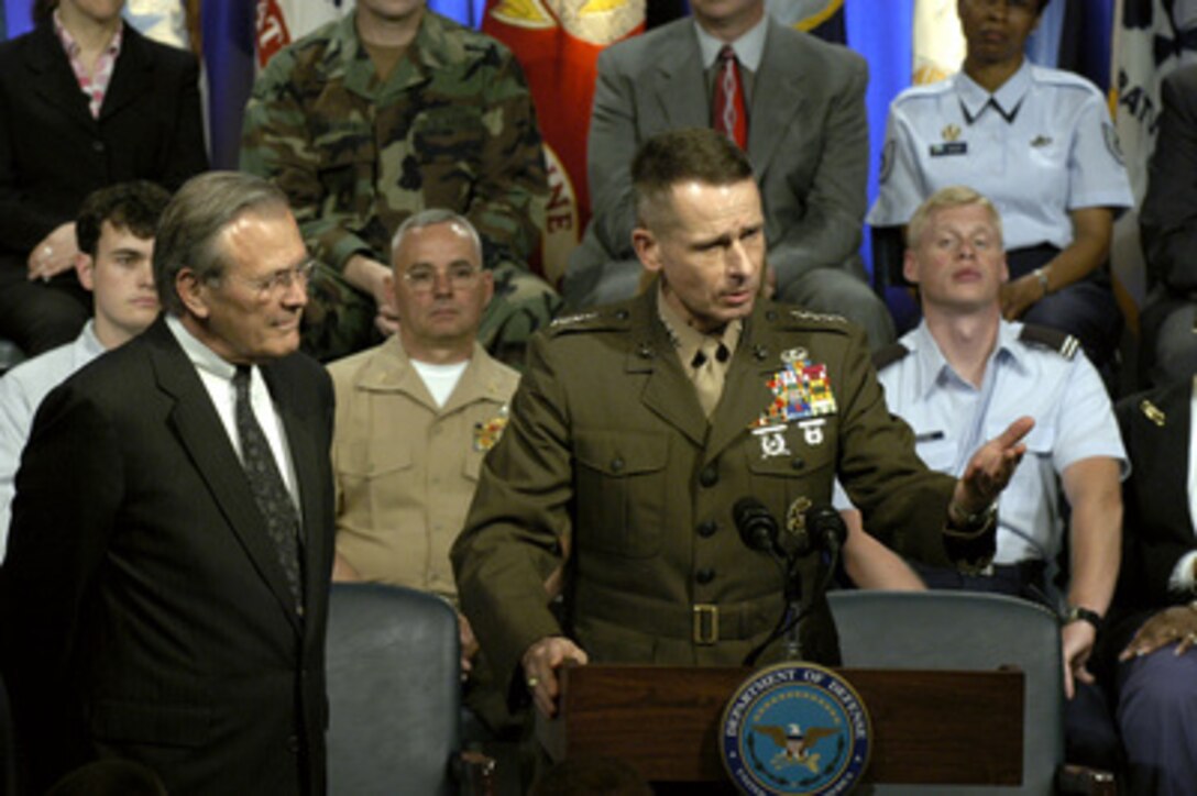 Secretary of Defense Donald H. Rumsfeld listens as Vice Chairman of the Joint Chiefs of Staff Gen. Peter Pace, U.S. Marine Corps, responds to a question during a Pentagon Town Hall meeting on May 11, 2004. Rumsfeld and Pace made opening remarks and then took questions from the audience of military and DoD civilians. 