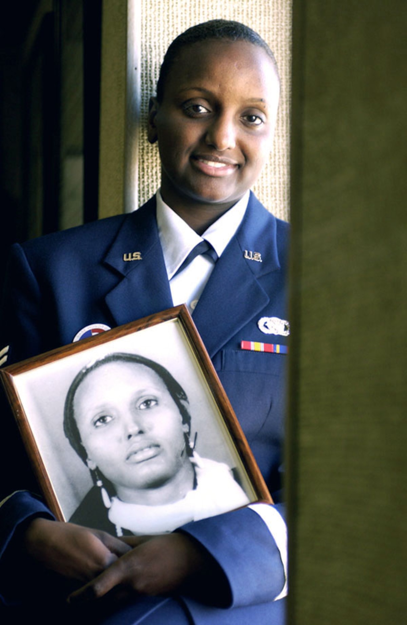 LANGLEY AIR BASE, Va. -- Airman 1st Class Ayaan Nduli holds a photo of her mother, Sahra Cali Sherwac.  Airman Nduli is attempting to take her family out of a refugee camp in Kenya and bring them to the United States.  (U.S. Air Force photo by Tech. Sgt. Ben Bloker)
