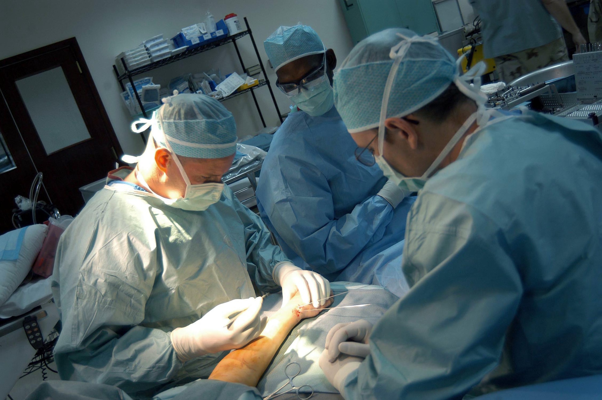 SOUTHWEST ASIA -- Maj. (Dr.) Warren Kadrmas prepares to make an incision to fix a patient's fractured wrist.  He is an orthopedic surgeon assigned to a mobile-field surgical team at a forward-deployed location.  Dr. Kadrmas is deployed from Lackland Air Force Base, Texas.  (U.S. Air Force photo by Airman Alexis Lloyd)