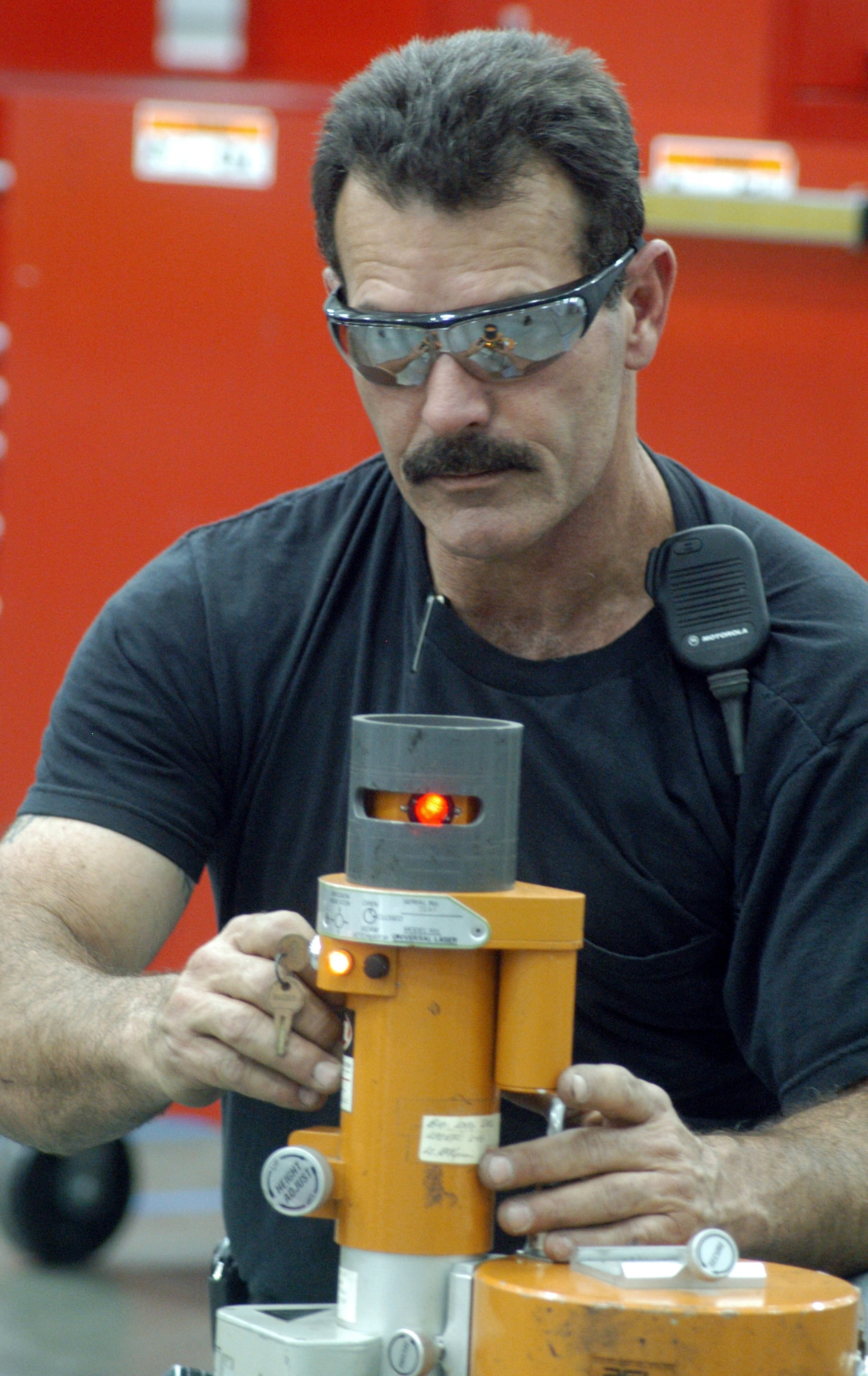 ROBINS AIR FORCE BASE, Ga. -- Robert Hollar calibrates a laser leveler used to assure everything is in perfect alignment.  Mr. Hollar is a millwright, or metal structure mechanic, here. (U.S. Air Force photo by Sue Sapp)