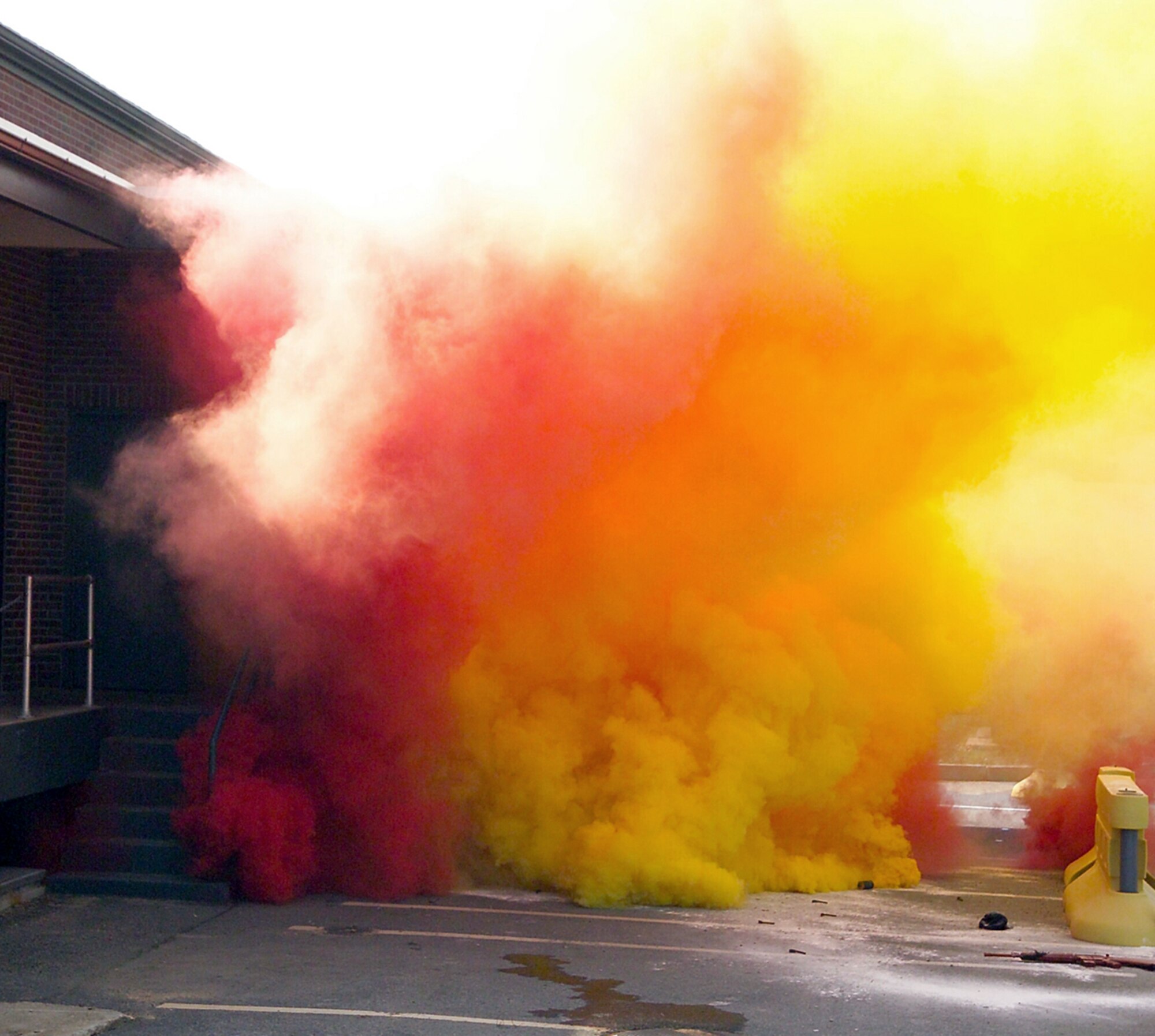 NEW BOSTON AIR FORCE STATION, N.H. -- A simulated terrorist attack begins here May 15 during exercise Granite Thunder 2004.  The exercise encompassed more than 20 local, state and federal agencies to respond to the attack that combined explosives with chemical agents.  The attack was simulated using red and yellow smoke grenades, along with ground burst simulators.  (U.S. Air Force photo by Mark Wyatt)