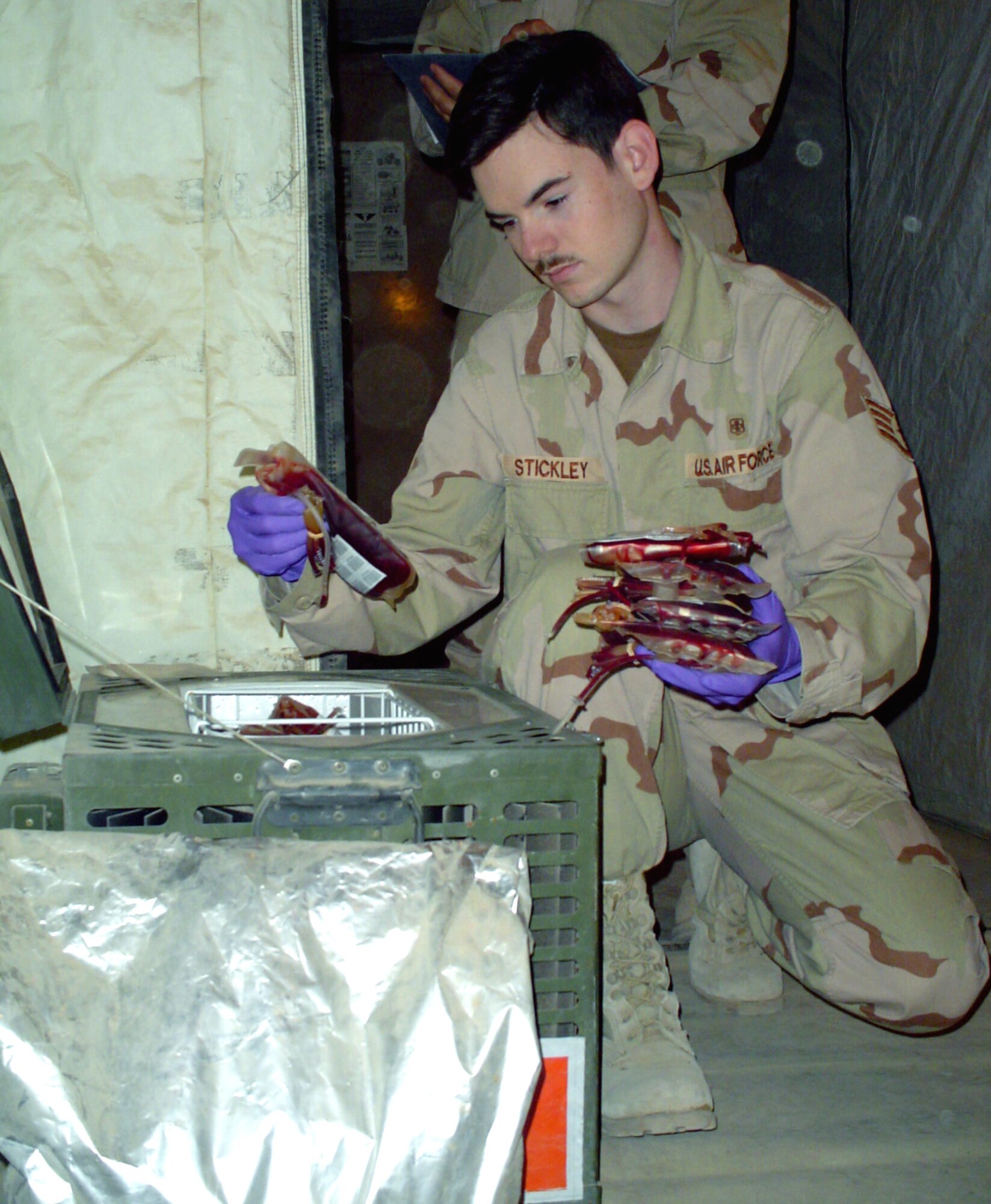 CAMP SATHER, Iraq -- Staff Sgt. Matthew Stickley, a medical technician, checks the 447th Expeditionary Medical Squadron's blood supply here.  Technicians account for the blood, which is stored in refrigeration units at the beginning and end of every shift.  The units can store up to 35 pints each.  (U.S. Air Force photo by Master Sgt. Sean E. Cobb)