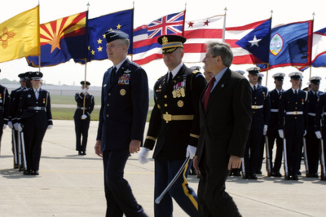 The Third U.S. Infantry Regimental Commander Col. Charles Taylor, U.S. Army, (center) escorts Chairman of the Joint Chiefs of Staff Gen. Richard B. Myers (left) and Deputy Secretary of Defense Paul Wolfowitz (right) during the inspection of troops. The ceremony marked the opening of the annual Armed Forces Open House and Air Show at Andrews Air Force Base, Md., on May 14, 2004. 