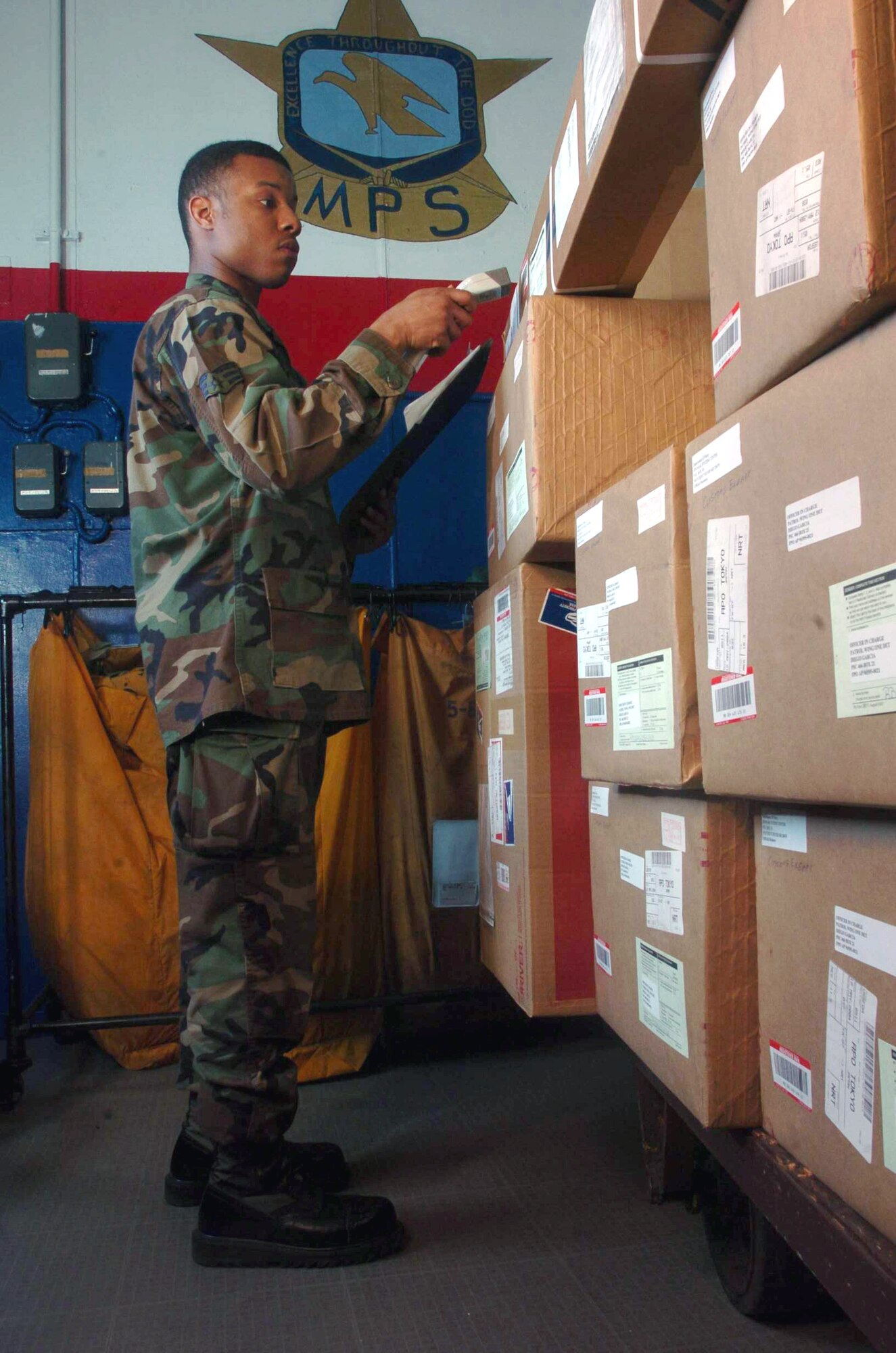 YOKOTA AIR BASE, Japan -- Senior Airman Stacey Bailey uses a scanner to track registered mail at the mail processing facility here.  He is assigned to Detachment 2 of the Air Postal Squadron.  The detachment oversees the movement, sorting and distribution of more than 50 million pounds of mail annually.  (U.S. Air Force photo by Master Sgt.Val Gempis)