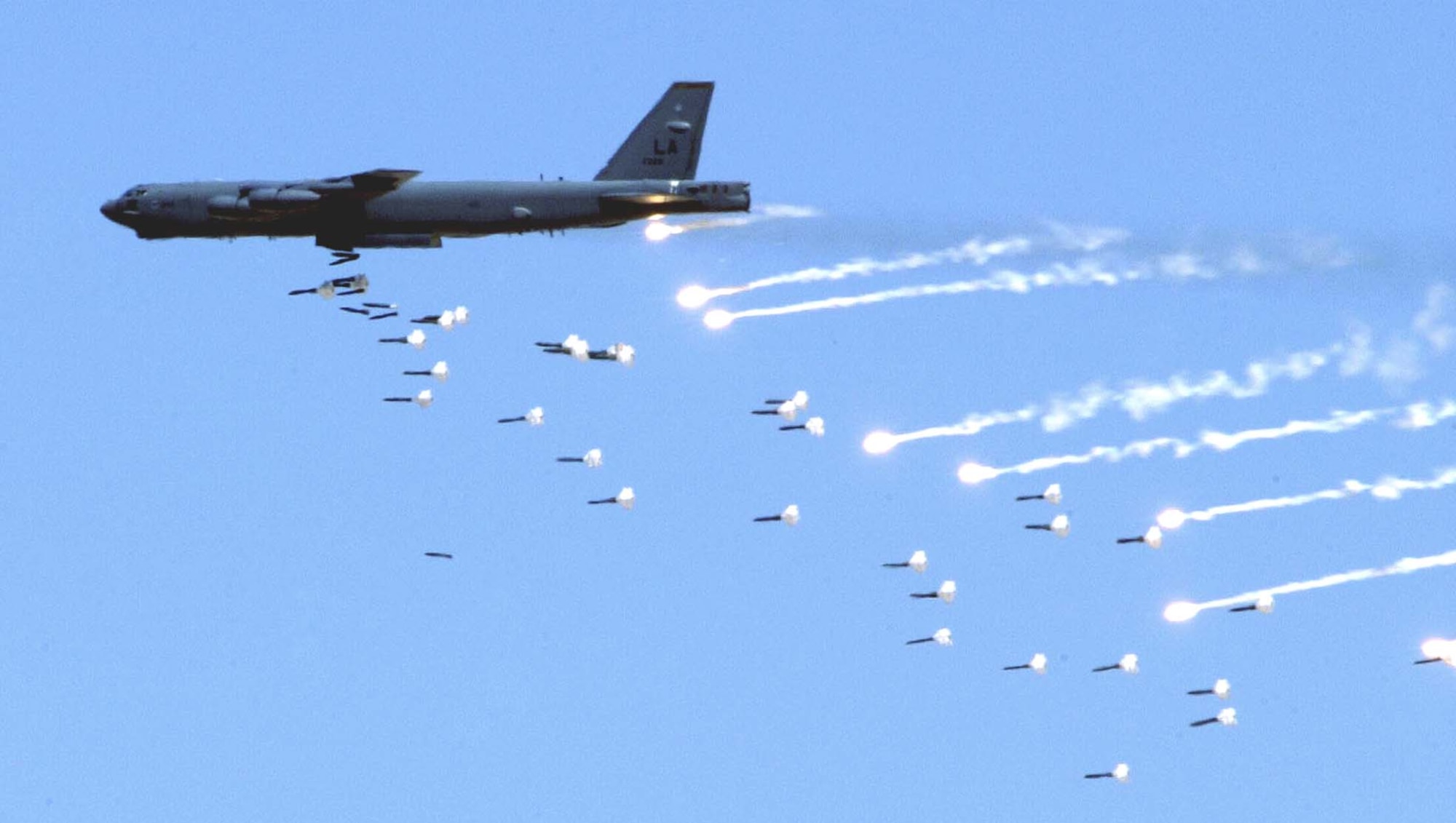 NELLIS AIR FORCE BASE, Nev. -- A B-52 Stratofortress from Barksdale Air Force Base, La., drops live ordnance over the Nevada Test and Training Range near here May 12 during an Air Force firepower demonstration.  The demonstration showcases the Air Force's air and space capabilities.  (U.S. Air Force photo by Senior Airman Brian Ferguson)                           