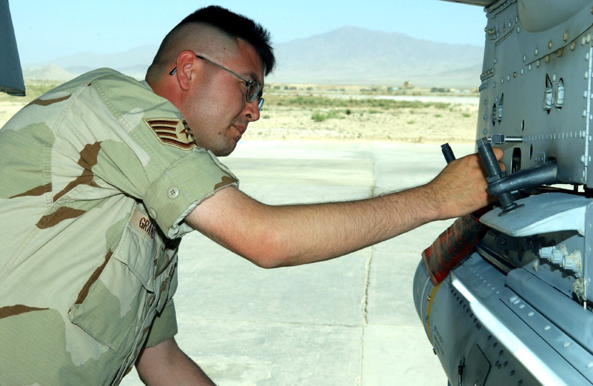 BAGRAM AIR BASE, Afghanistan -- Staff Sgt. Thomas Grandstaff inspects an A-10 Thunderbolt II on the flightline here to make sure the AGM-65 Maverick missile is securely loaded.  He is the 455th Air Expeditionary Wing weapons safety manager.  (U.S. Air Force photo by Master Sgt. Jeff Szczechowski)