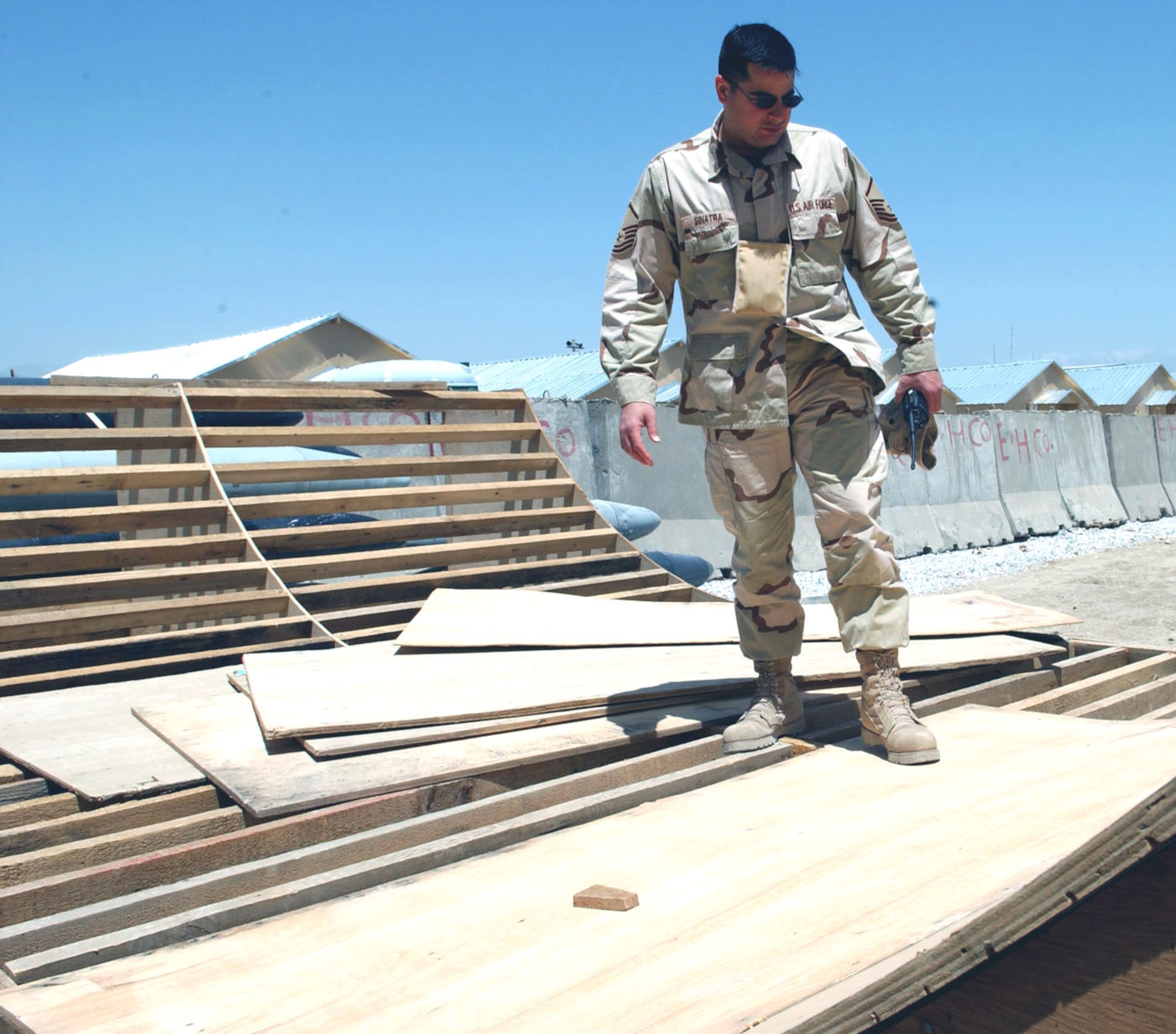 BAGRAM AIR BASE, Afghanistan -- Master Sgt. Steve Sinatra looks over a skateboard ramp Airmen here are building.  Airmen in the safety office keep an eye out for on-duty and off-duty safety hazards around the base.  Sergeant Sinatra is the 455th Air Expeditionary Wing ground safety manager.  (U.S. Air Force photo by Master Sgt. Jeff Szczechowski)