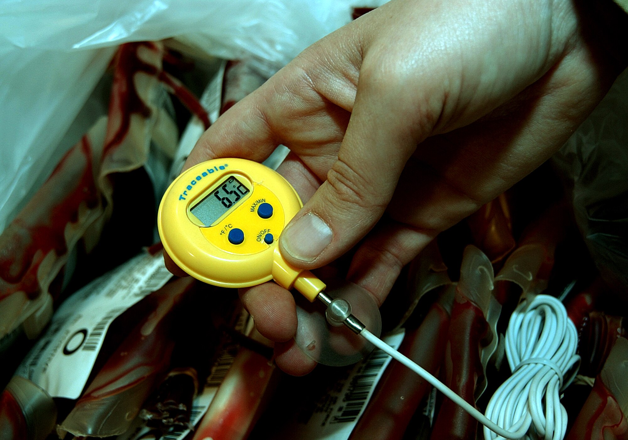 AL UDEID AIR BASE, Qatar -- A member of the blood transshipment center staff takes a temperature reading of 6.5 degrees Celsius on a box of blood before it is stored.  The temperature must remain between 1 and 10 degrees Celsius while it is being catalogued.  When it is shipped, blood is packed in plastic foam and ice until it gets to the appropriate place, where it is then refrigerated until needed.  (U.S. Air Force photo by Airman 1st Class J.G. Buzanowski)