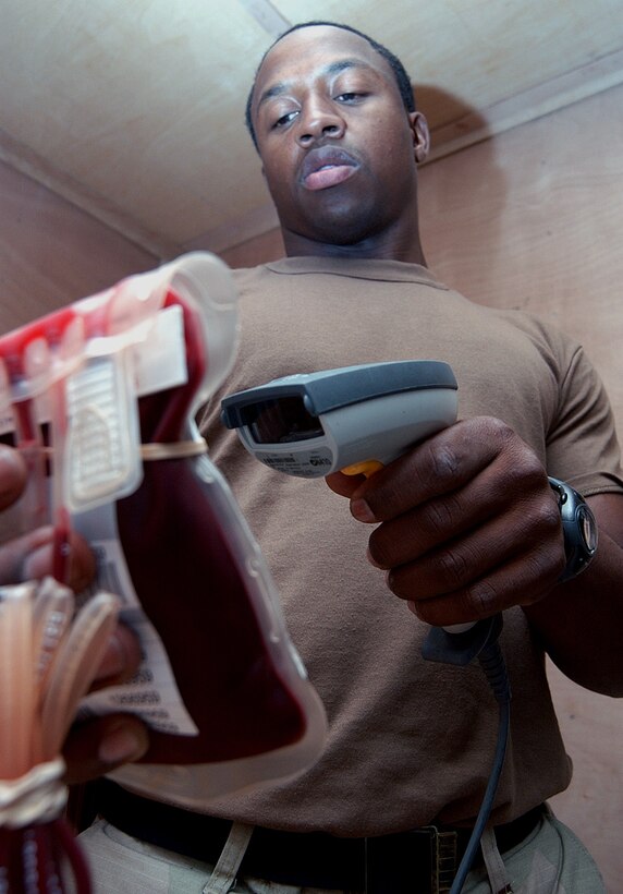 AL UDEID AIR BASE, Qatar -- Airman 1st Class Covito Redman scans a bag of blood here May 14.  The Airmen in the 379th Expeditionary Medical Group's blood transshipment center can track blood from donor to recipient and everywhere in between because of accountability procedures.  Airman Redman is deployed from Davis-Monthan Air Force Base, Ariz.  (U.S. Air Force photo by Airman 1st Class J.G. Buzanowski)