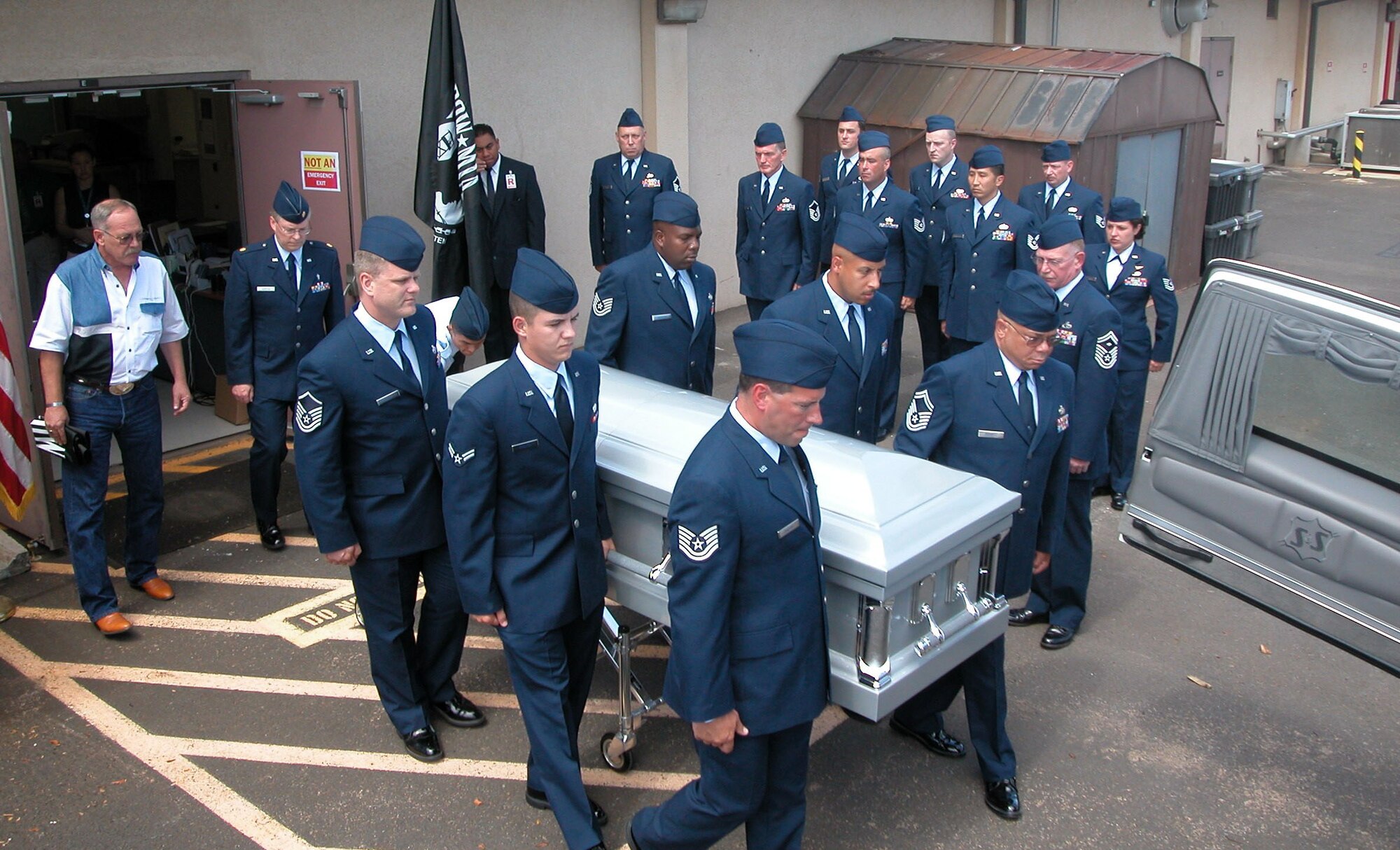 HICKHAM AIR FORCE BASE, Hawaii -- Airmen of the 36th Aerial Port Squadron carry the remains of Col. Lester Holmes out of the Joint POW/MIA Accounting Command here May 18.  Colonel Holmes' son, Senior Master Sgt. Roger Holmes, is the first sergeant for the squadron based at McChord Air Force Base, Wash.  The colonel was missing in action in Vietnam since May 22, 1967.  His remains were recently identified after they were recovered in 1998, and he will be laid to rest May 22 with full military honors in Nashua, Iowa.  (U.S. Air Force photo by Staff Sgt. Wendy Beauchaine)