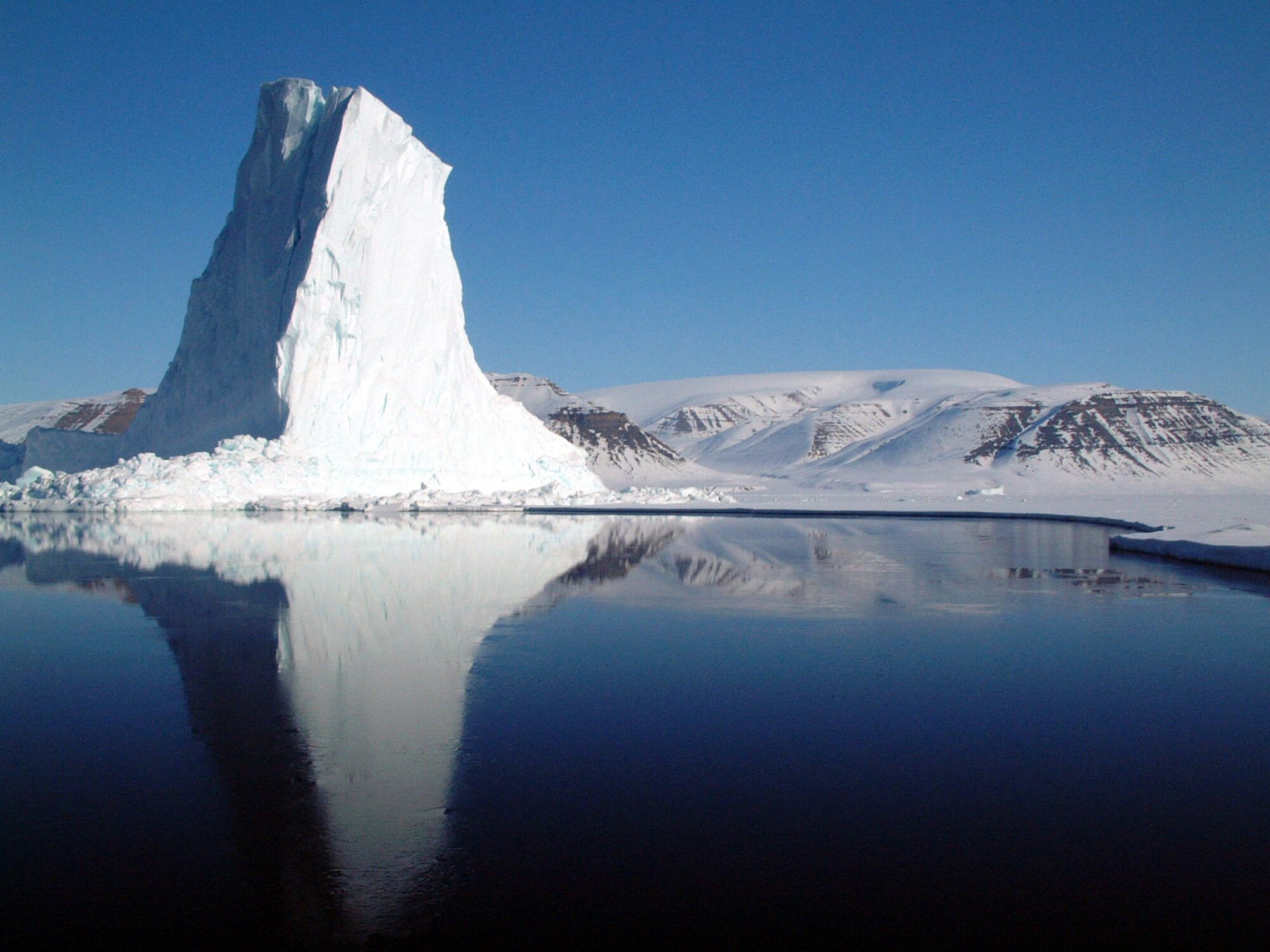 GREENLAND -- An iceberg at the edge of the Baffin Bay's sea ice is just one of the many sights three Airmen from Thule Air Base, Greenland, witnessed recently during a six-day dog-sledding expedition.  (U.S. Air Force photo by Tech. Sgt. Dan Rea)