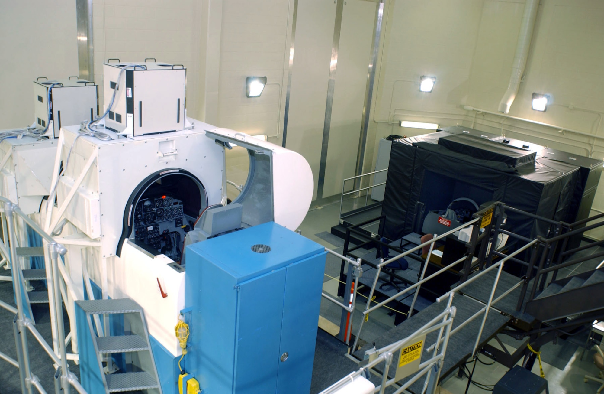 RANDOLPH AIR FORCE BASE, Texas -- The two-story tall T-38A Talon analog simulator (left) towers over the new T-38C virtual reality trainer in the 12th Flying Training Wing's simulator building here.  (U.S. Air Force photo by Javier Garcia)
