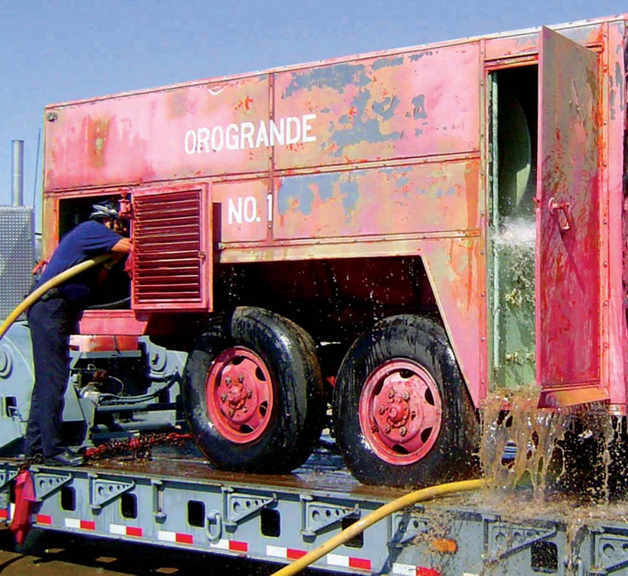 HOLLOMAN AIR FORCE BASE, N.M. -- Larry Daniels, a Holloman firefighter, cleans out the O-6 Cardox fire crash truck after it was donated by a local firefighter's union.  The truck sat for 30 years and was infested by rodents and covered in sand.  Firefighters here restored the vehicle and donated it to the military firefighter's heritage museum at Goodfellow Air Force Base, Texas.  (Courtesy photo)