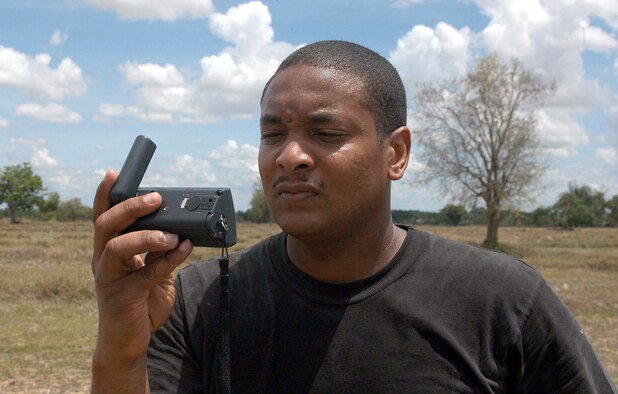 BAN NONG SONG, Thailand -- Master Sgt. Andre Baker checks a Global Positioning System device at a drop zone during Cobra Gold 04.  Cobra Gold is an exercise designed to improve U.S., Thai, Singaporean, Mongolian and Filipino combined readiness and interoperability, enhance security relationships and demonstrate U.S. resolve in the region.  Sergeant Baker is assigned to the 353rd Operations Support Squadron at Yokota Air Base, Japan.  (U.S. Air Force photo by Master Sgt. Michael Farris)