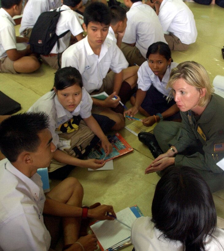 KORAT, Thailand -- Maj. Tiffani Donahue speaks with Thai 12th-graders during an English class she gave at a local school May 21 while here for Cobra Gold 04.  Cobra Gold is an exercise designed to improve U.S., Thai, Singaporean, Mongolian and Filipino combined readiness and interoperability, enhance security relationships and demonstrate U.S. resolve in the region.  Major Donahue is assigned to the 13th Air Force at Andersen Air Force Base, Guam.  (U.S. Army photo by Spc. Steven J. Schneider)