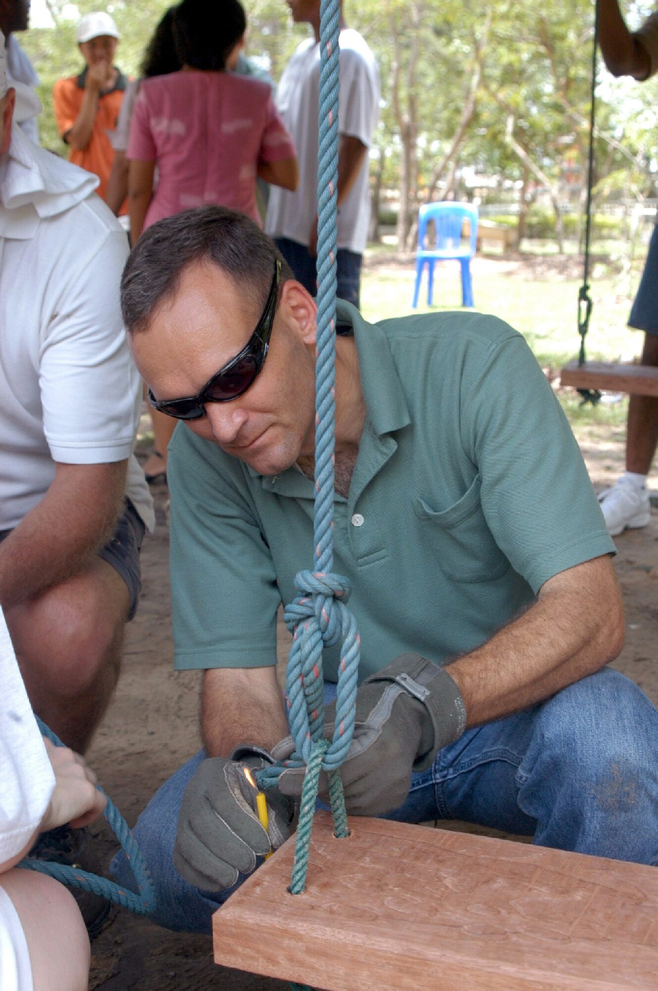 UDORN THANI, Thailand -- Chaplain (Capt.) Kleet Barclay sears the end of a rope on the new swing set at a preschool near here.  Airmen from the 353rd Special Operations Group from Kadena Air Base, Japan, visited the preschool to donate supplies and improve the students' playground.  (U.S. Air Force photo by Master Sgt. Michael Farris)