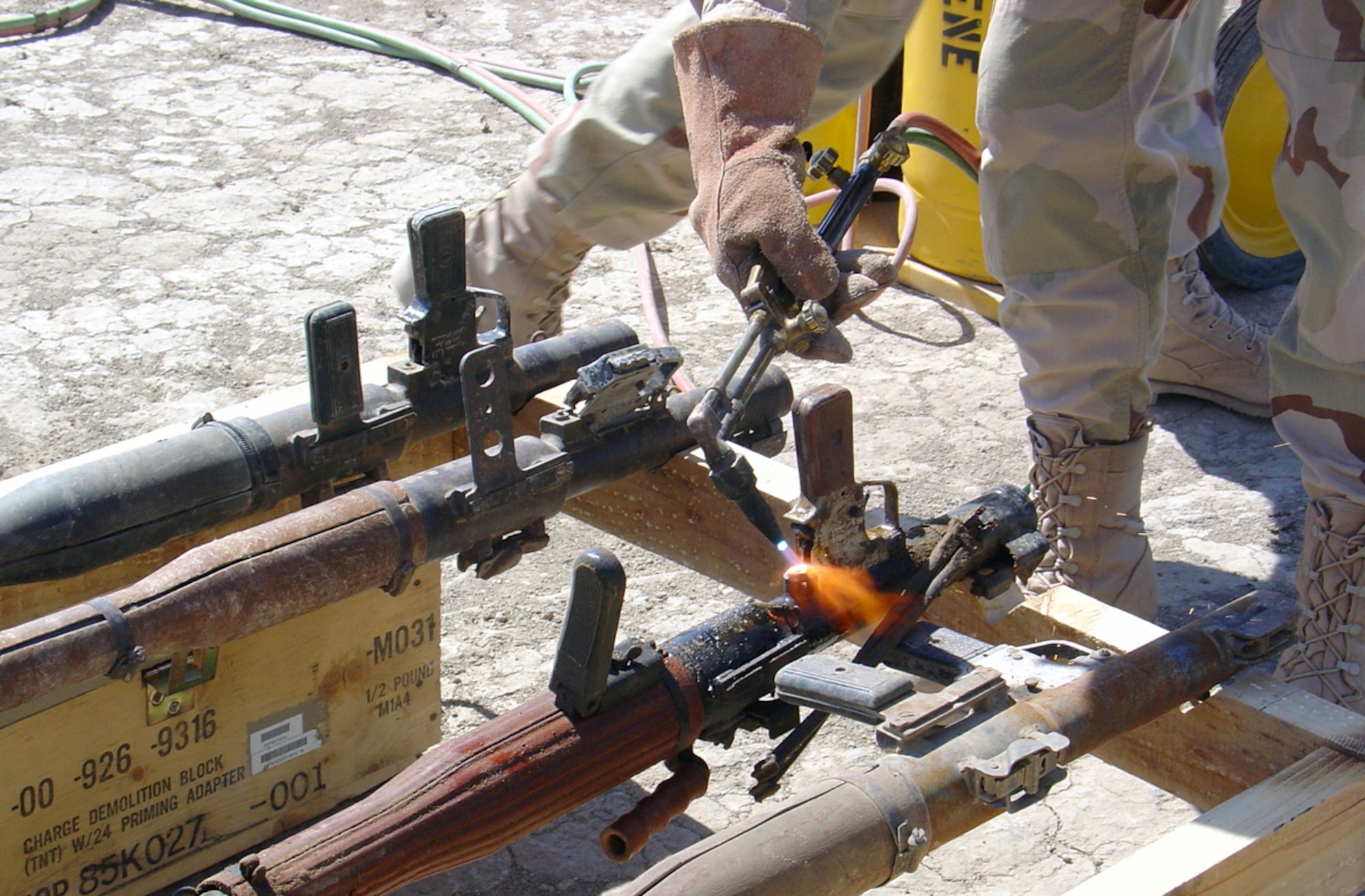 TALLIL AIR BASE, Iraq -- A structural craftsman from the 407th Expeditionary Civil Engineer Squadron destroys a rocket-propelled grenade launcher.  The squadron's Airmen here destroyed more than 600 launchers collected by coalition forces throughout southern Iraq.  (U.S. Air Force photo by Senior Master Sgt. Fernando Adams)