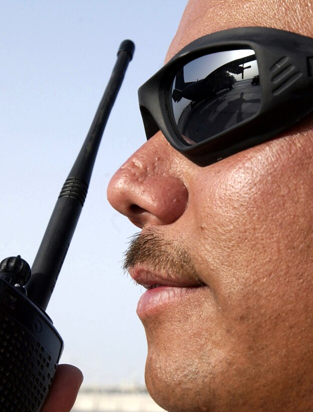 SOUTHWEST ASIA -- Staff Sgt. Darrin Padilla contacts ramp dispatch after loading a C-130 Hercules.  In March and April, Airmen from the 8th Expeditionary Air Mobility Squadron moved more than 10,000 short tons of cargo.  Sergeant Padilla is the load team chief and is deployed from Westover Air Reserve Base, Mass.  (U.S. Air Force photo by Tech. Sgt. Demetrius Lester)