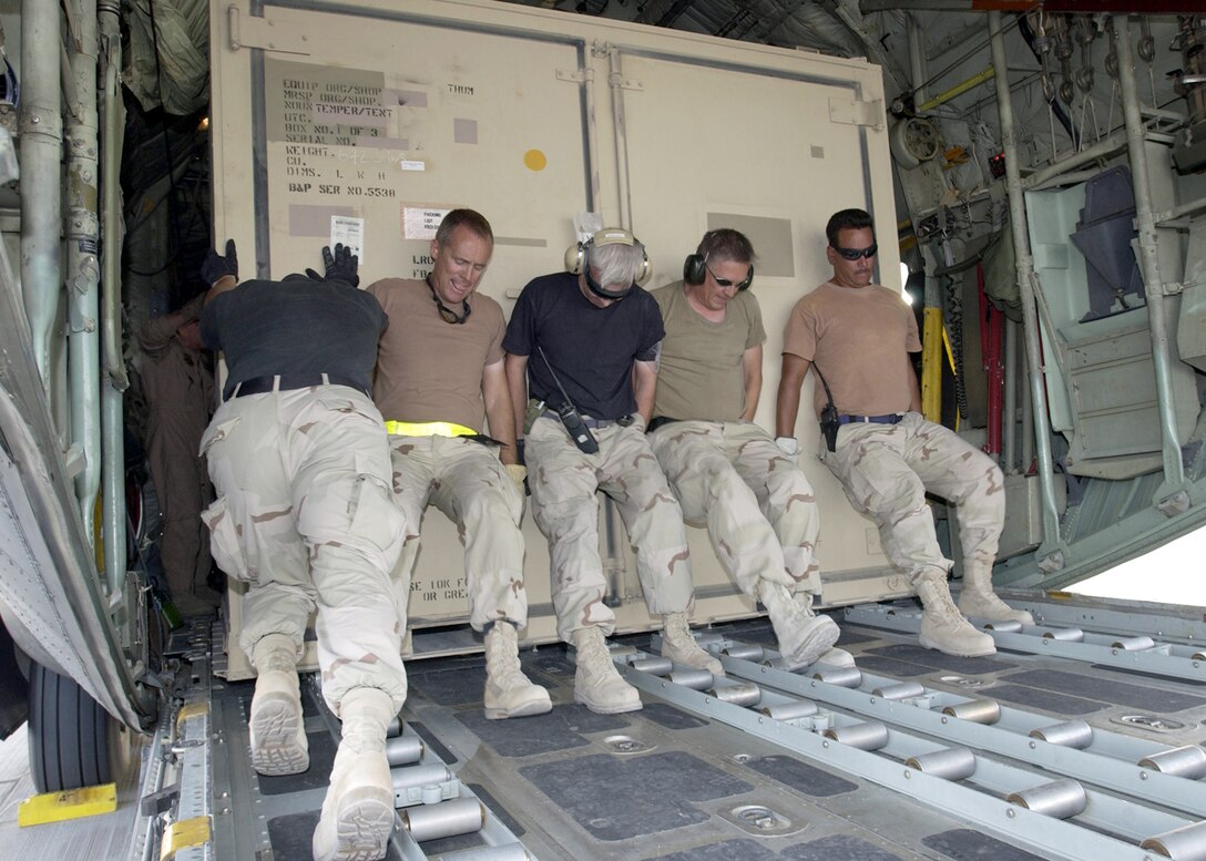 SOUTHWEST ASIA -- Airmen from the 8th Expeditionary Air Mobility Squadron's aerial port flight load cargo on a C-130 Hercules at a forward-deployed location.  In March and April, the Airmen moved more than 10,000 short tons of cargo.  (U.S. Air Force photo by Tech. Sgt. Demetrius Lester)