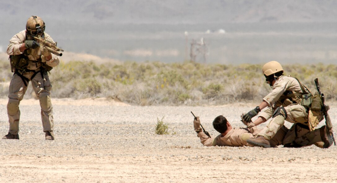 NELLIS AIR FORCE BASE, Nev. -- Pararescuemen from the 58th Rescue Squadron move in to rescue a downed pilot during a firepower demonstration on the bombing range here May 12. The firepower demonstration gave local civic leaders a bird's-eye view of some of the Air Force's capabilities in a wartime environment. (U.S. Air Force photo by Senior Airman Kenny Kennemer)